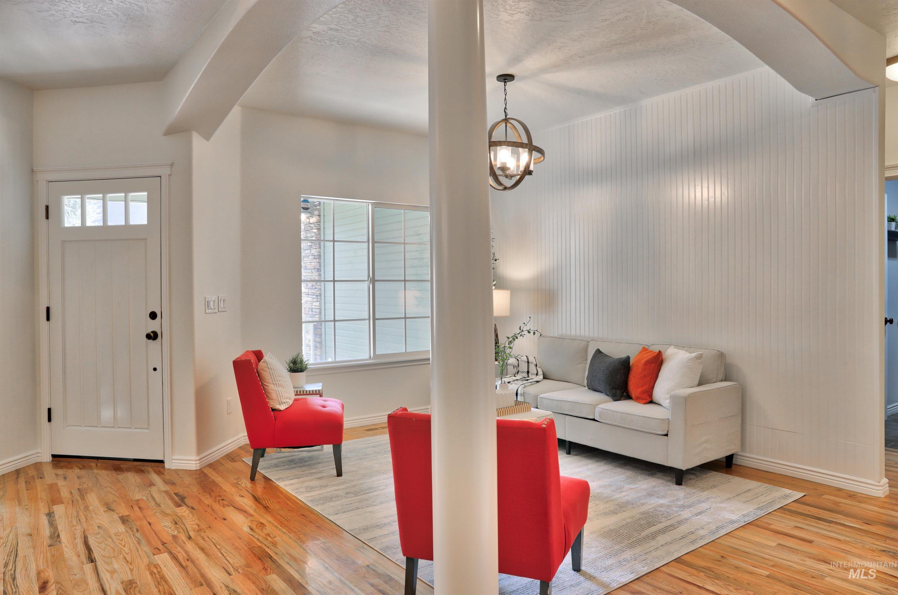 Foyer featuring healthy amount of natural light, light wood-type flooring, and a textured ceiling
