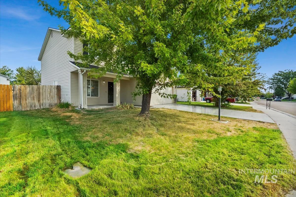 Obstructed view of property with concrete driveway, a garage, and a patio area