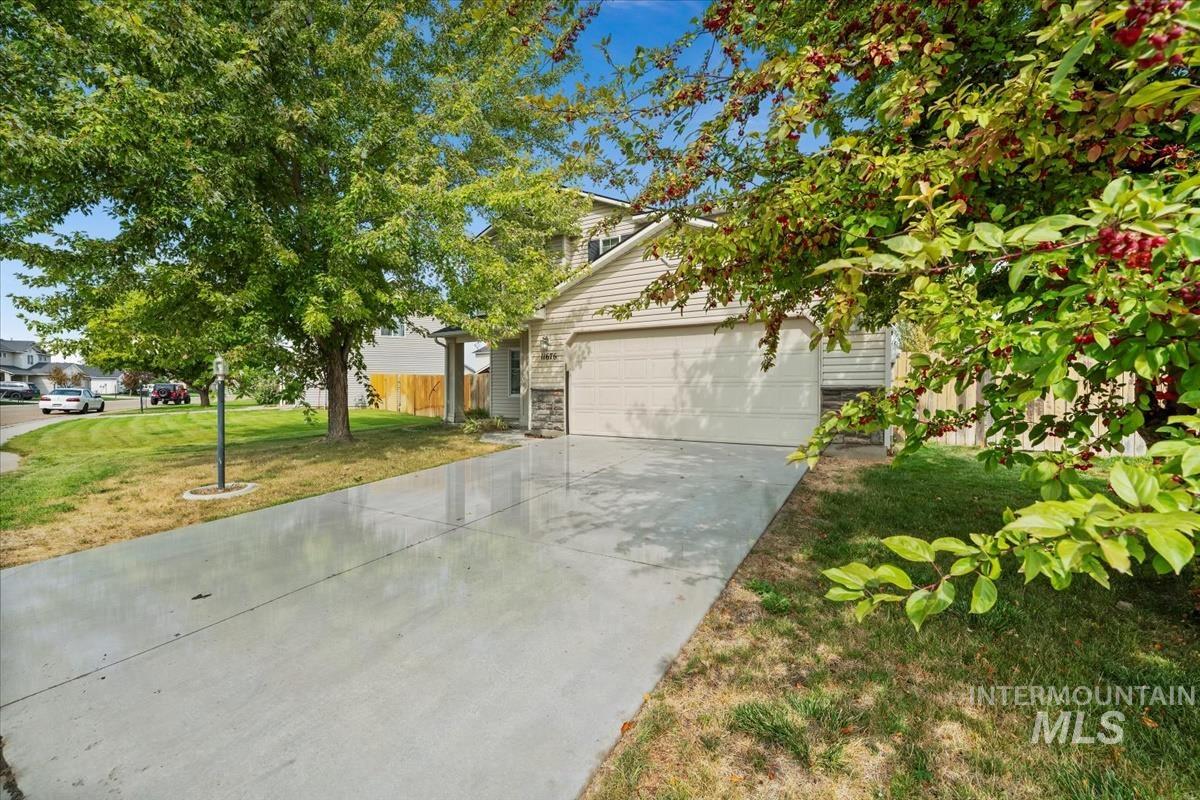 Obstructed view of property with concrete driveway and an attached garage