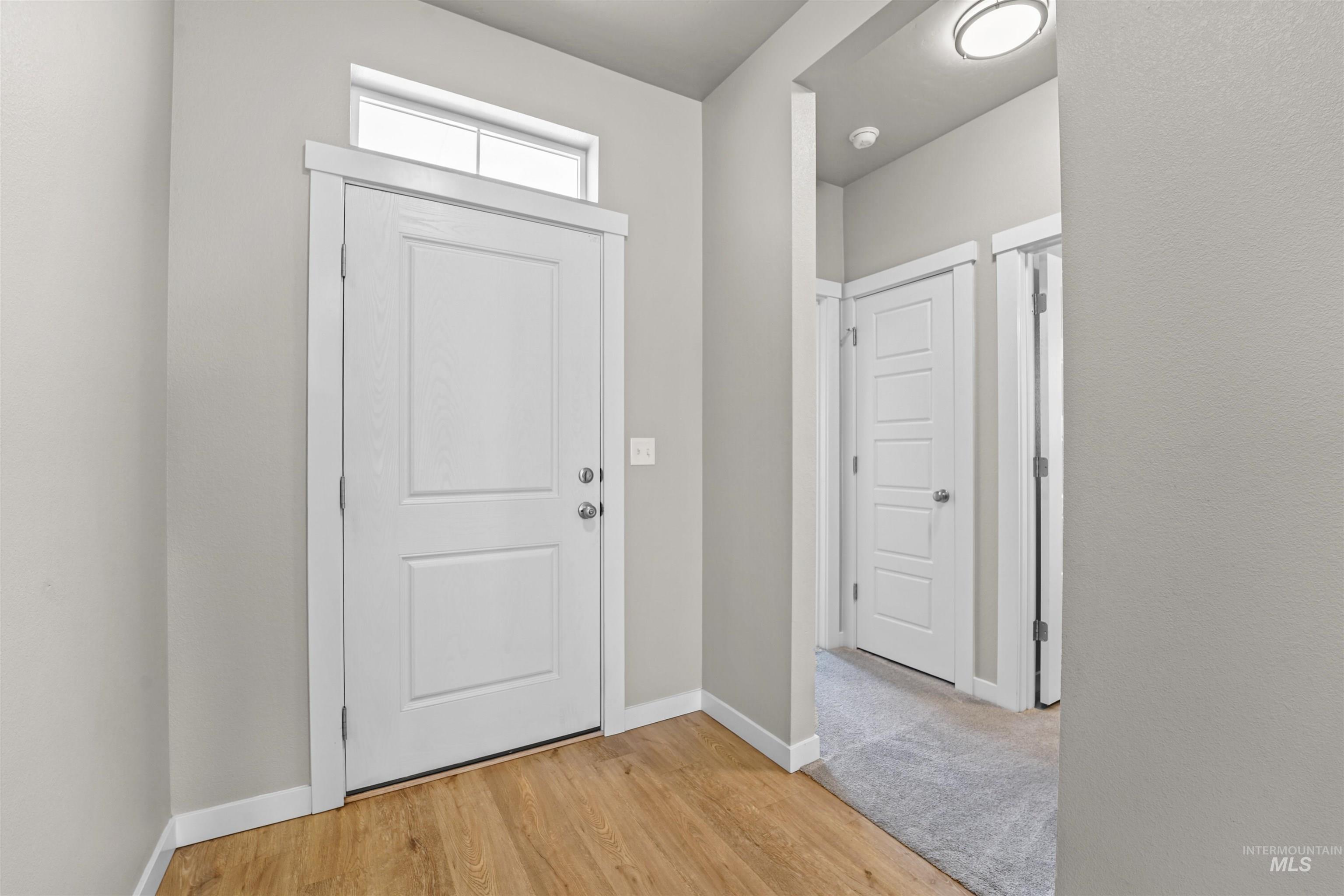 Foyer featuring baseboards and light wood-type flooring