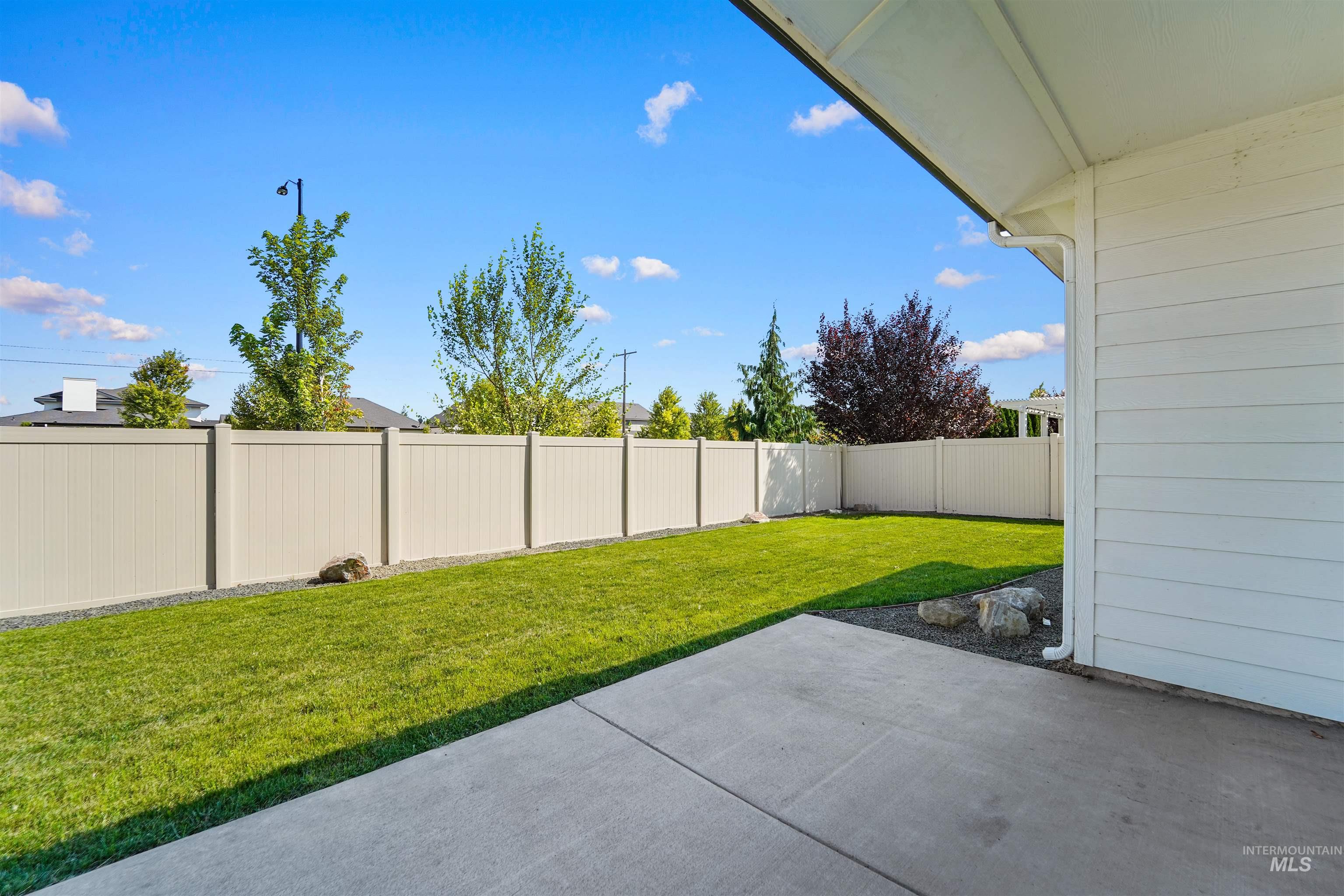 Fenced backyard featuring a patio