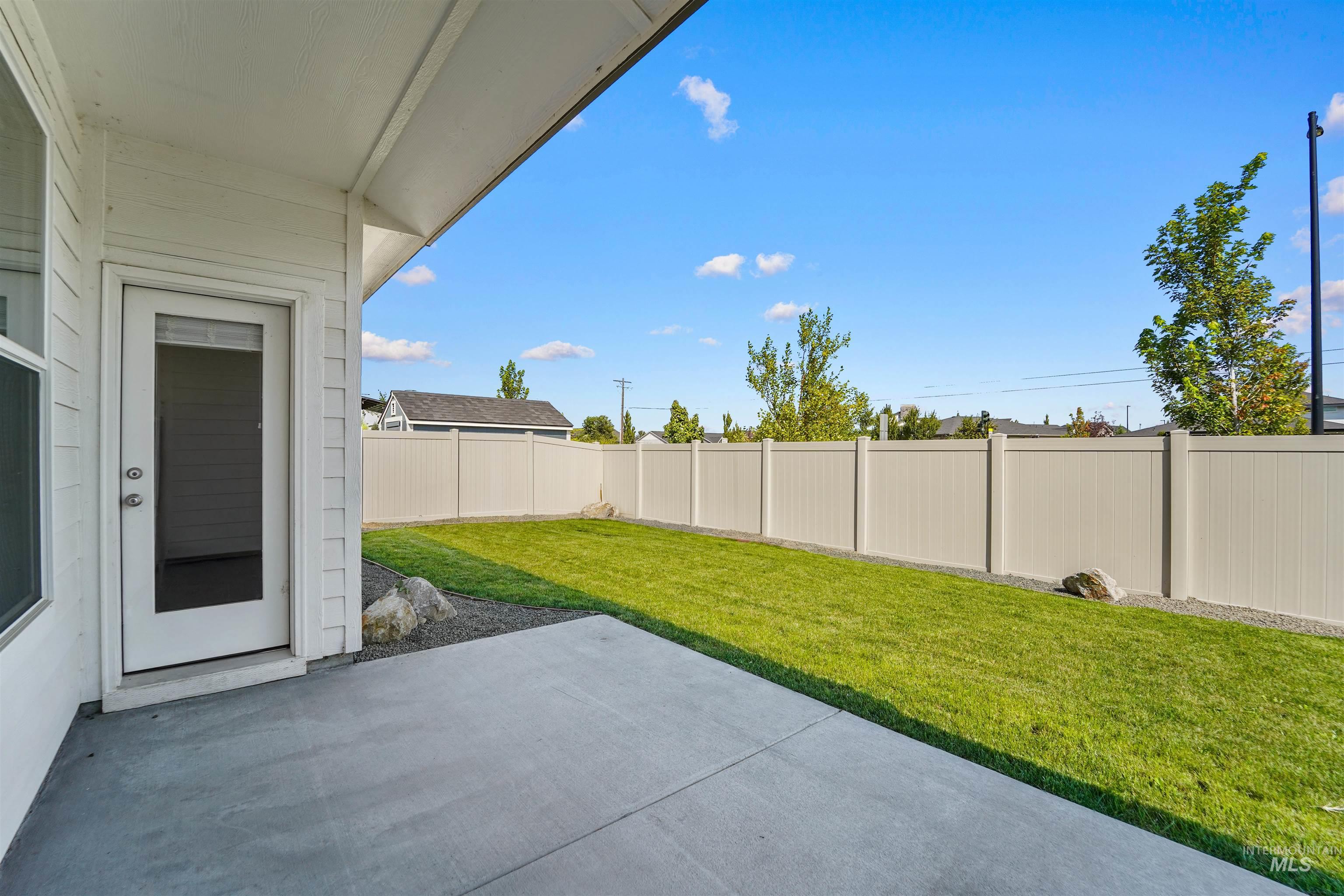 Fenced backyard with a patio area