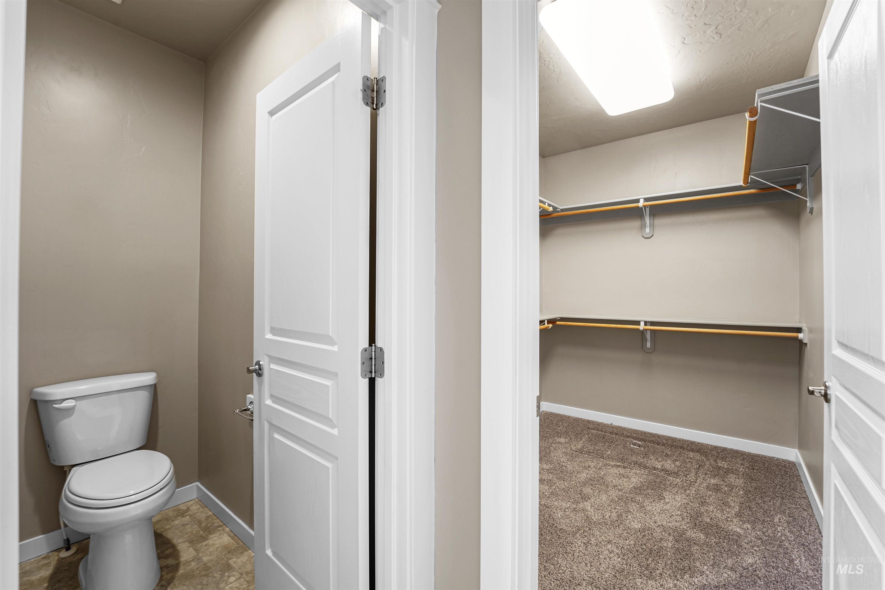 Bathroom with baseboards and a spacious closet