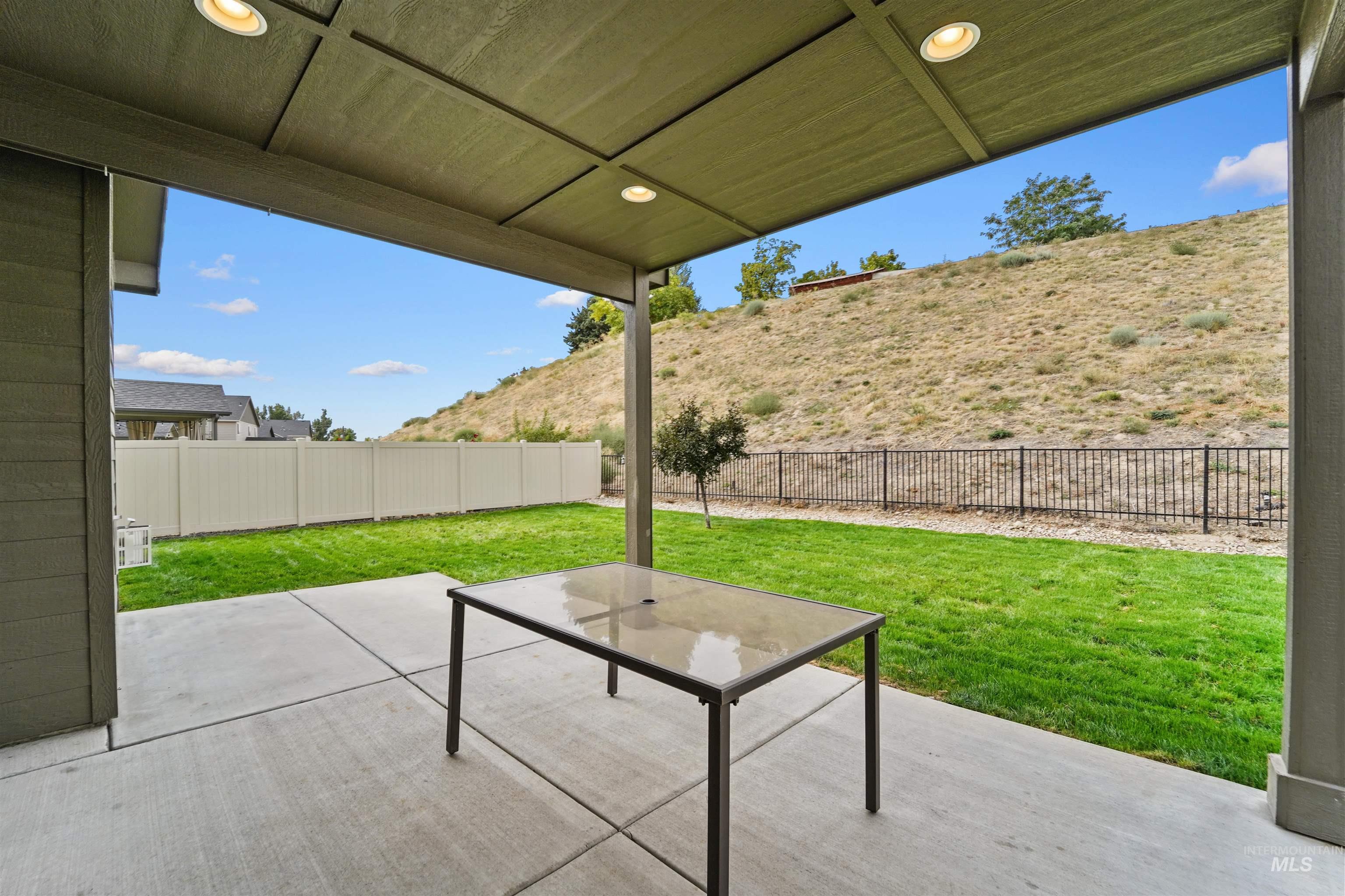 Fenced backyard with a patio area