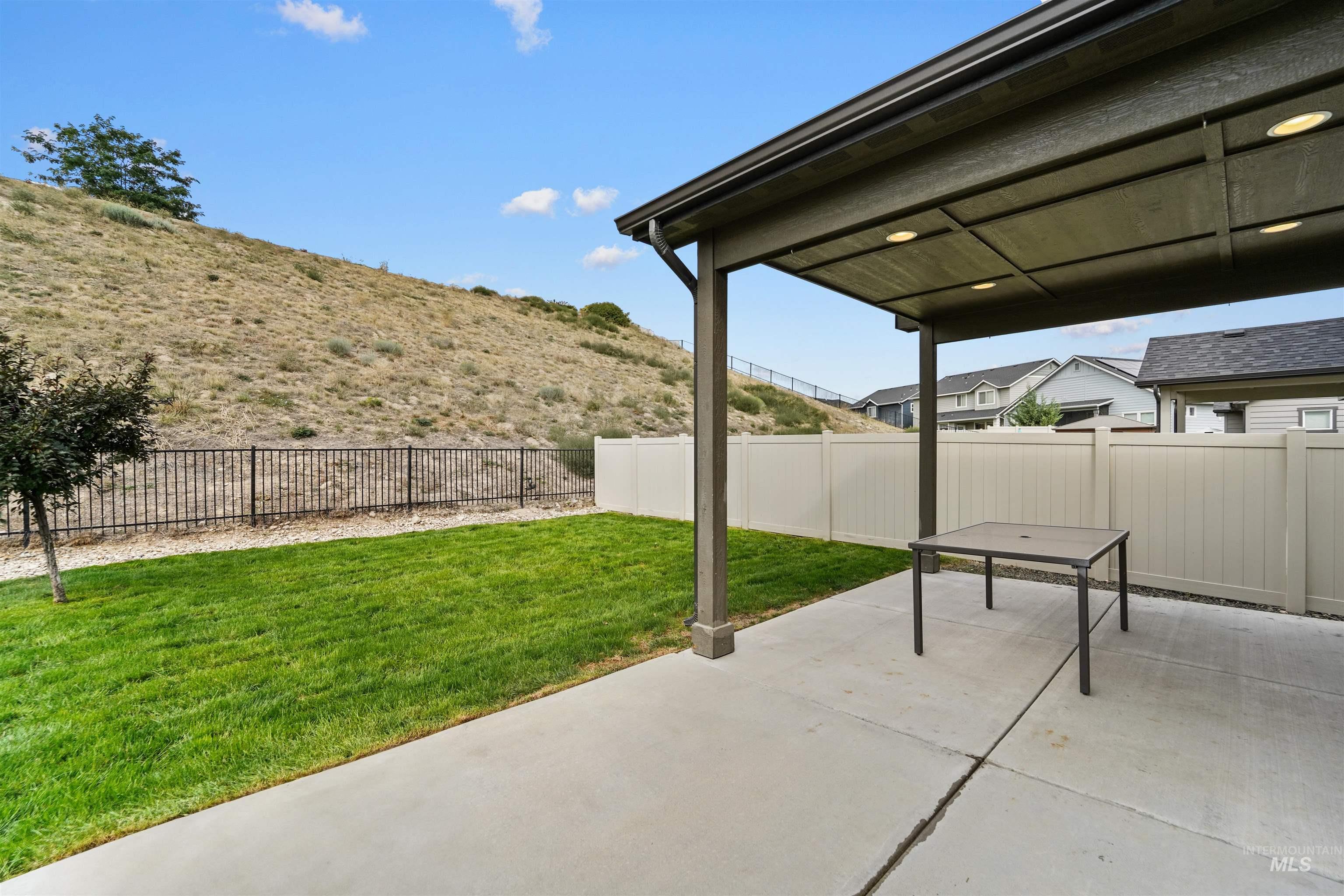Fenced backyard with a patio