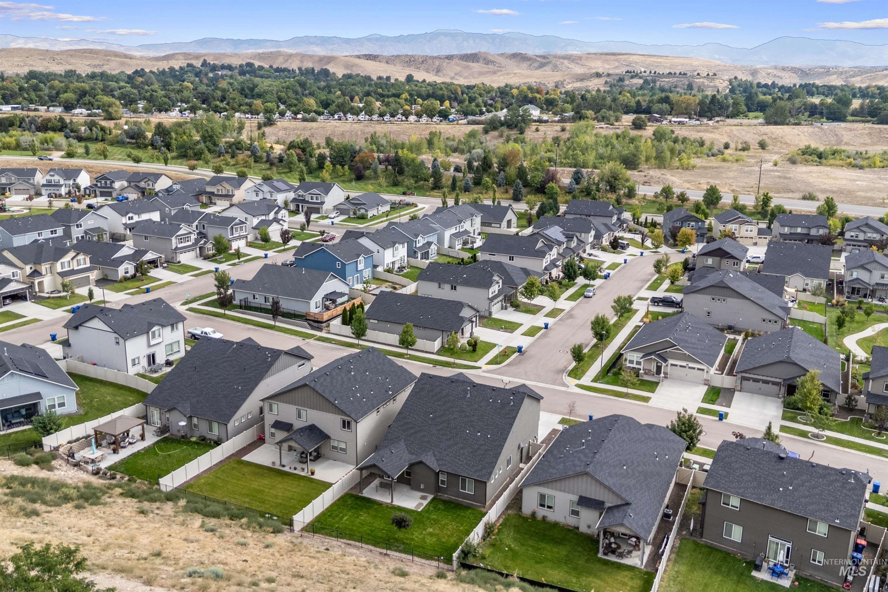 Aerial perspective of suburban area with a mountain backdrop