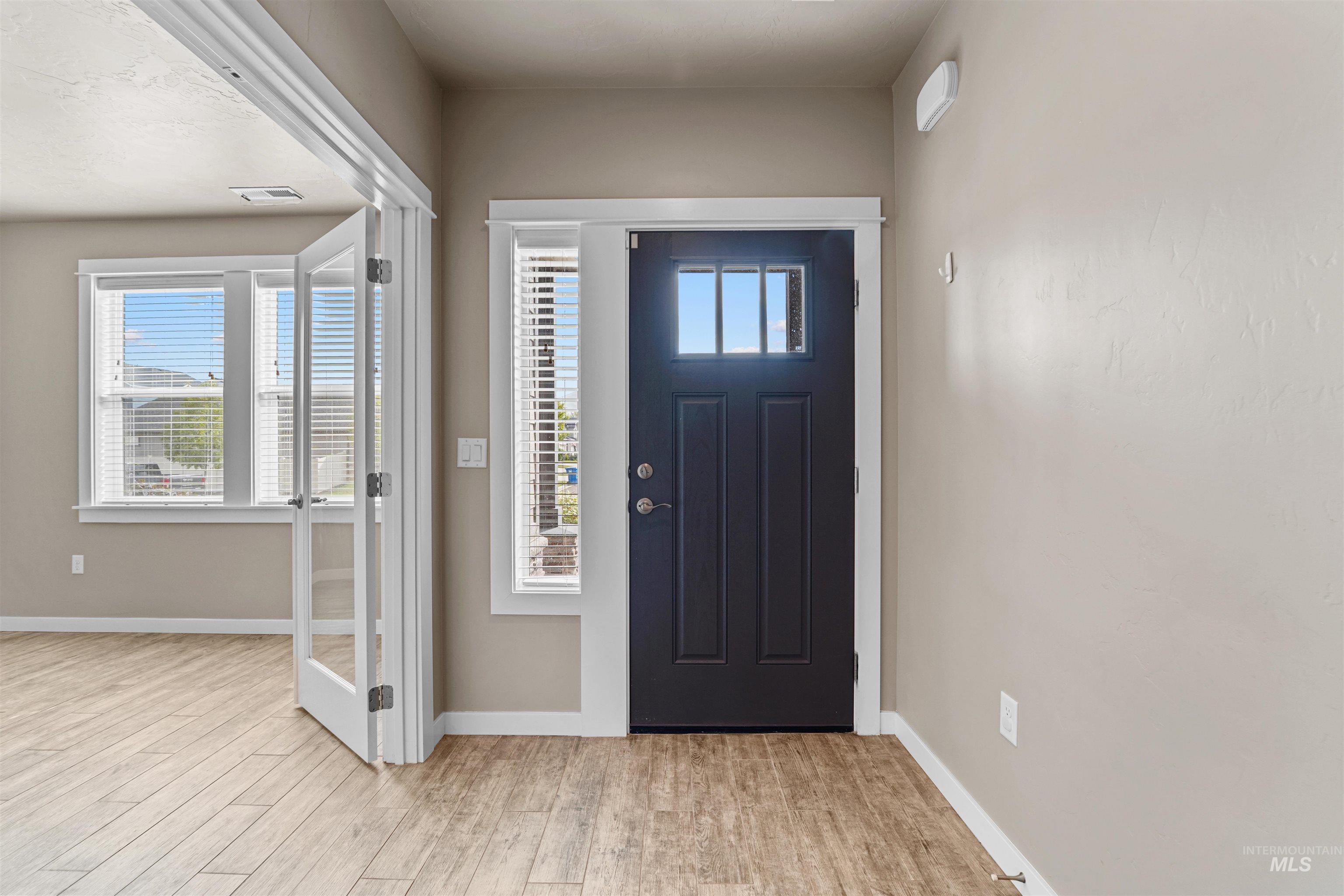 Foyer featuring baseboards and light wood-style floors