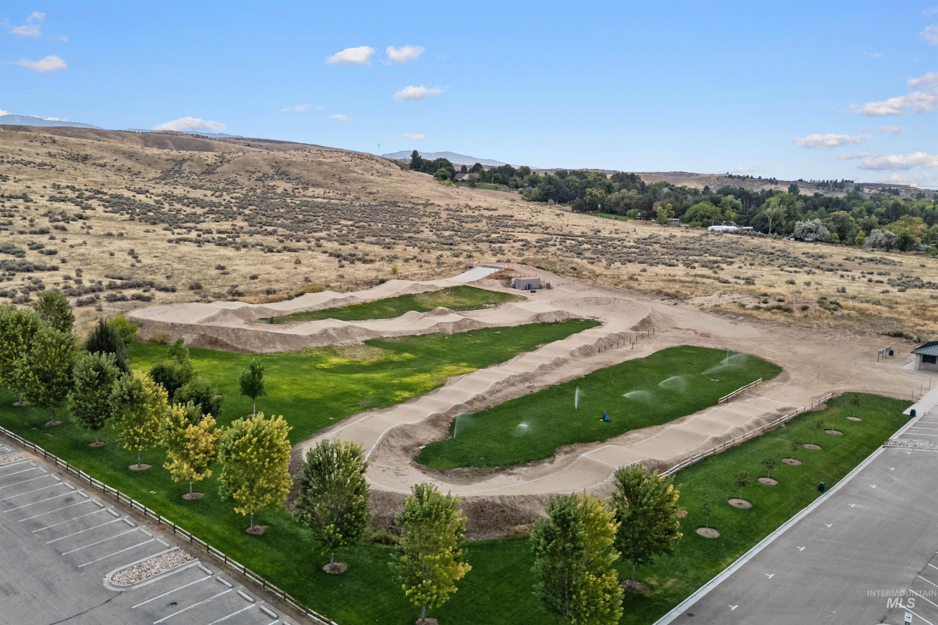 Aerial overview of property's location with rural landscape and a mountain backdrop