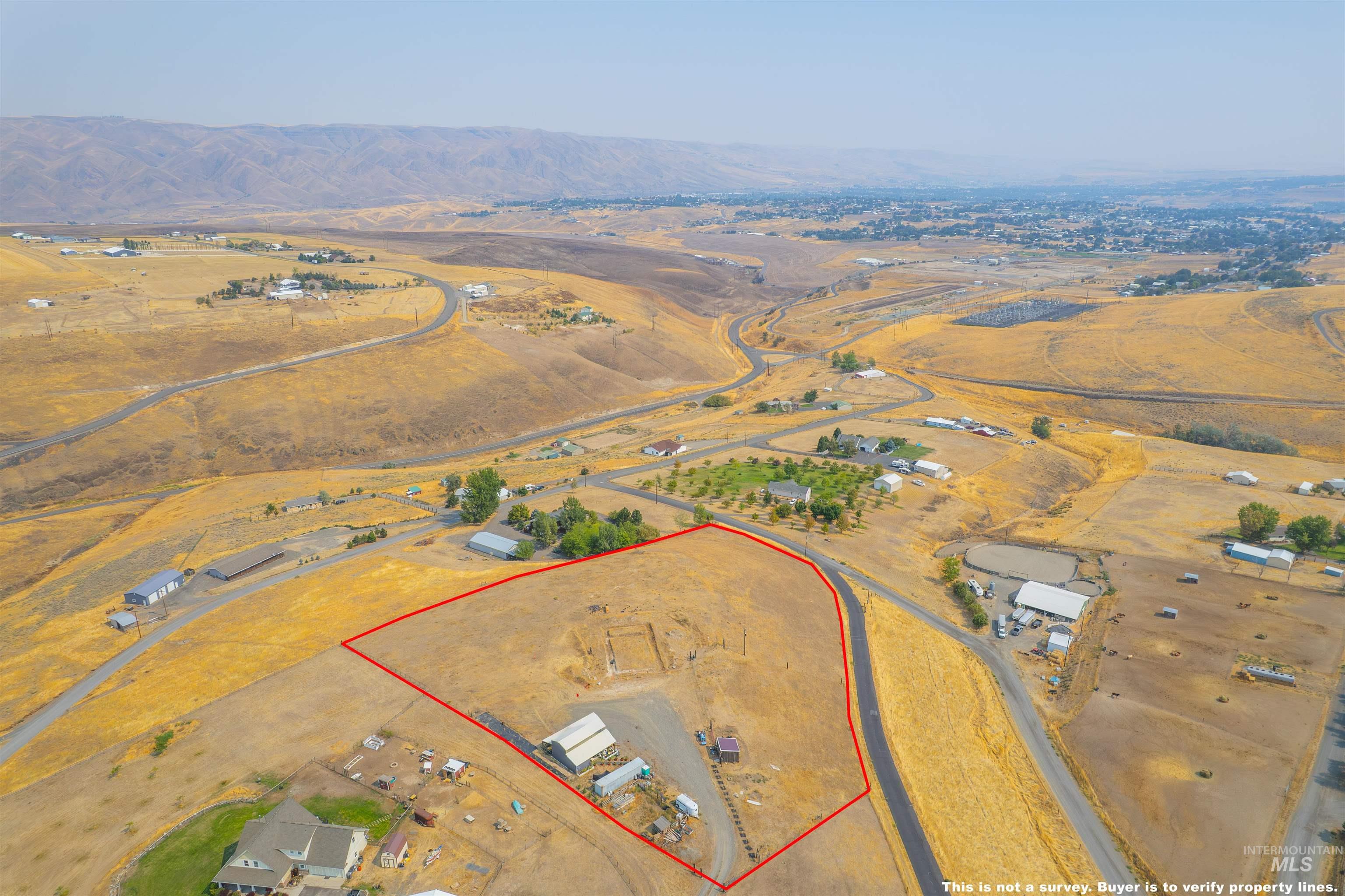 Aerial view of sparsely populated area with property boundaries highlighted and mountains