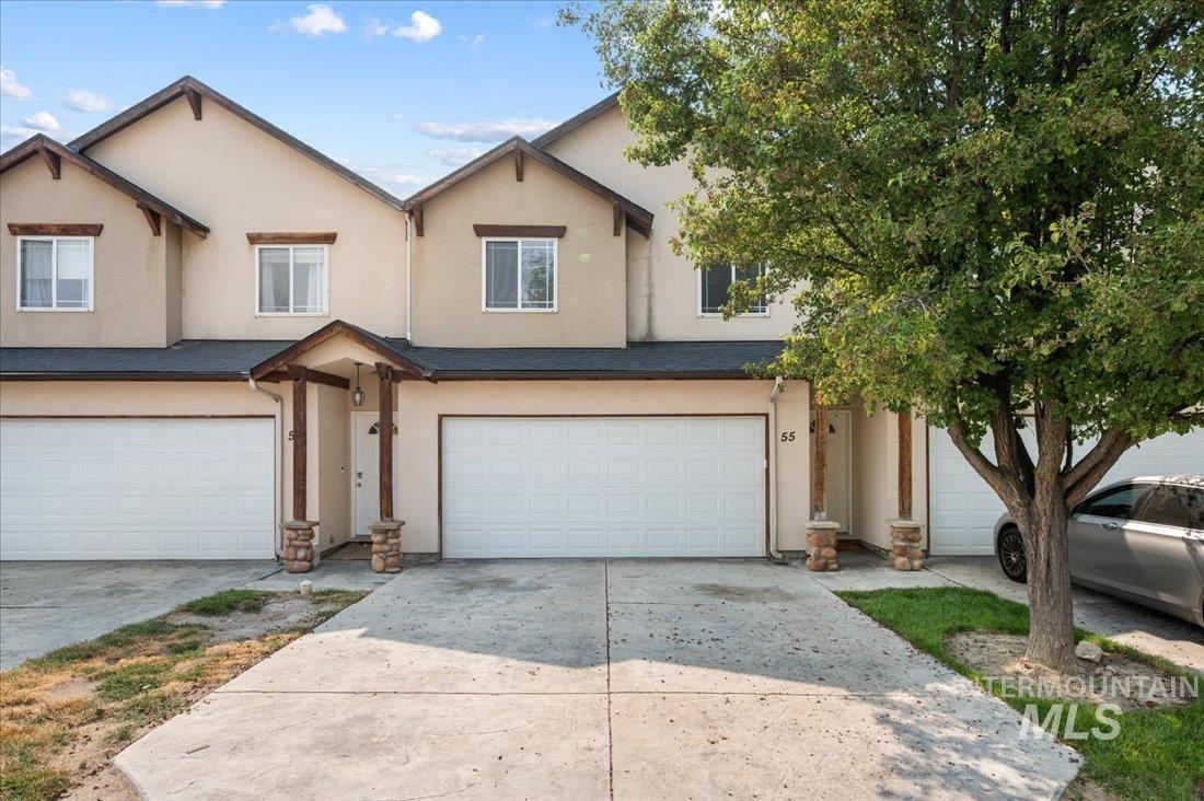 Traditional-style home with stucco siding and driveway