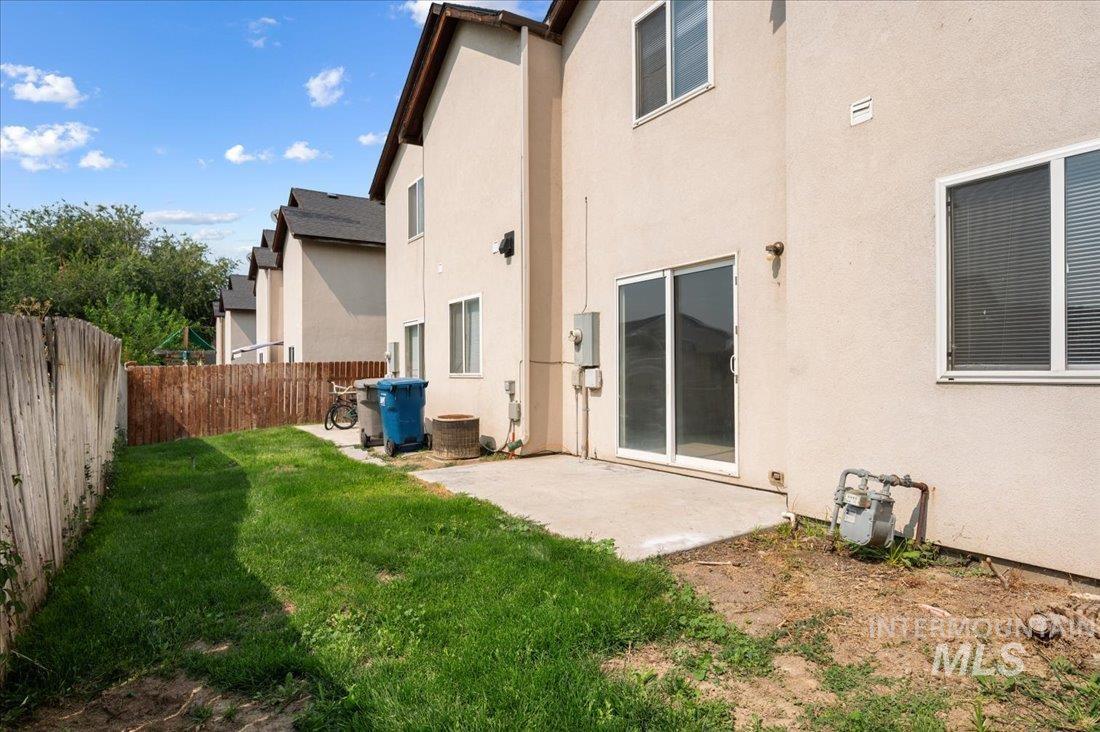 Back of property featuring a patio area and stucco siding