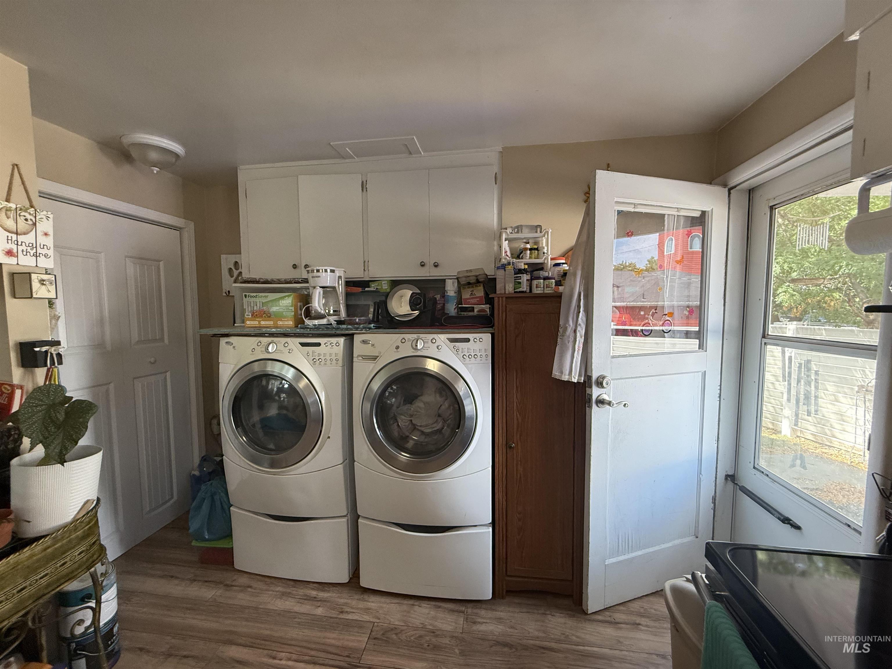 Laundry area with dark wood-style floors and washer and clothes dryer