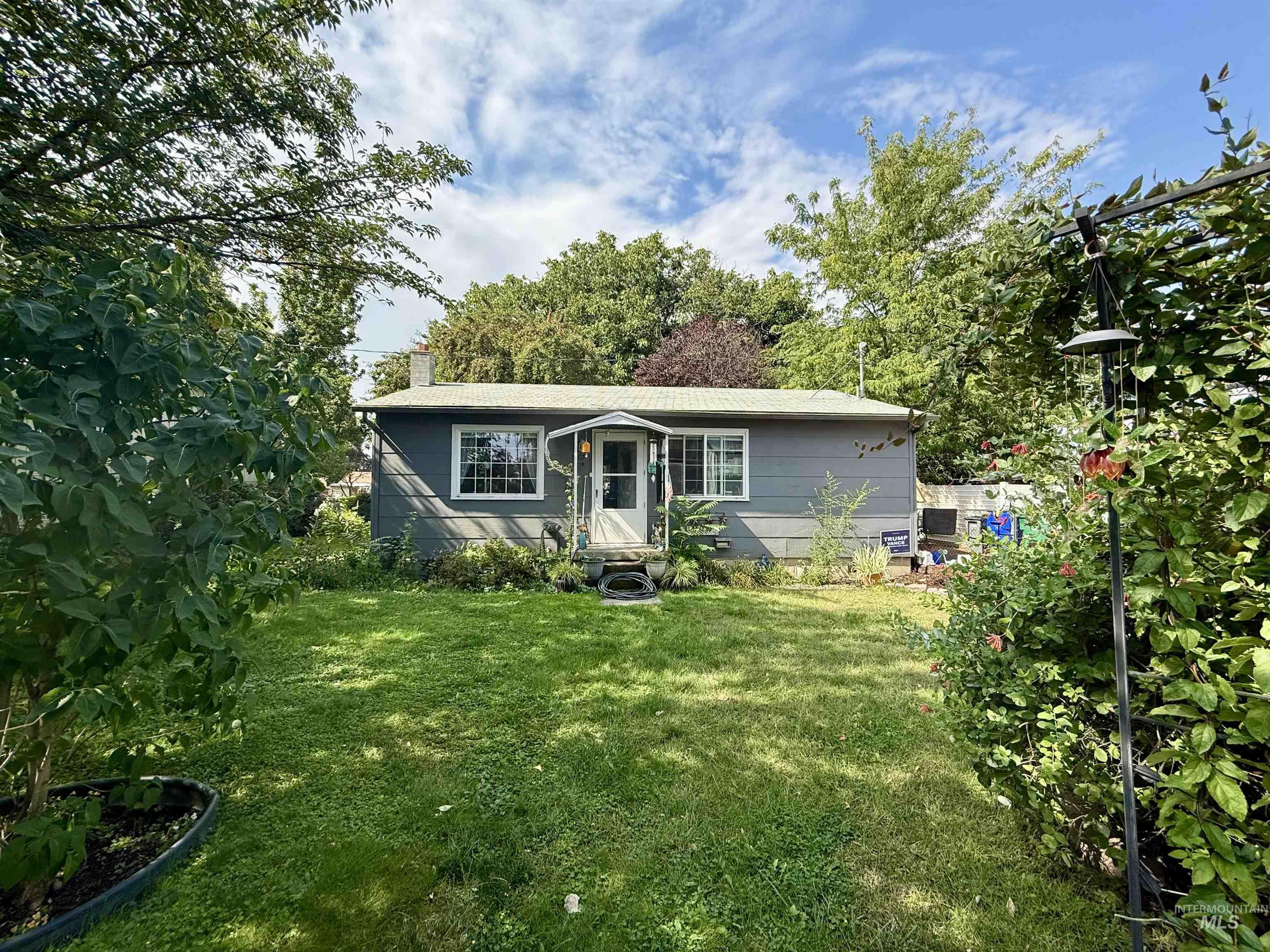 View of front of property featuring a front lawn and a chimney