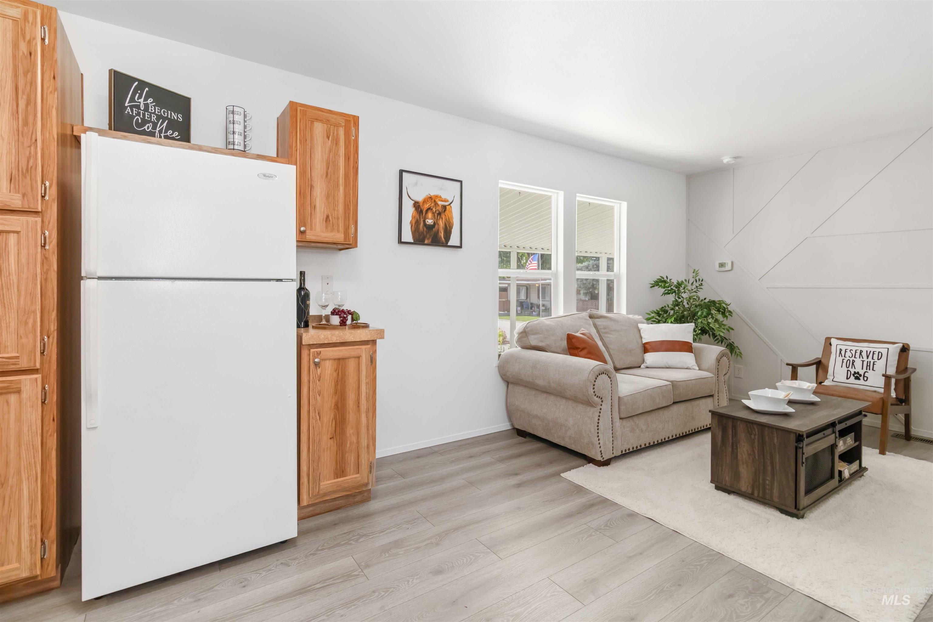 Living room with light wood-style floors and baseboards