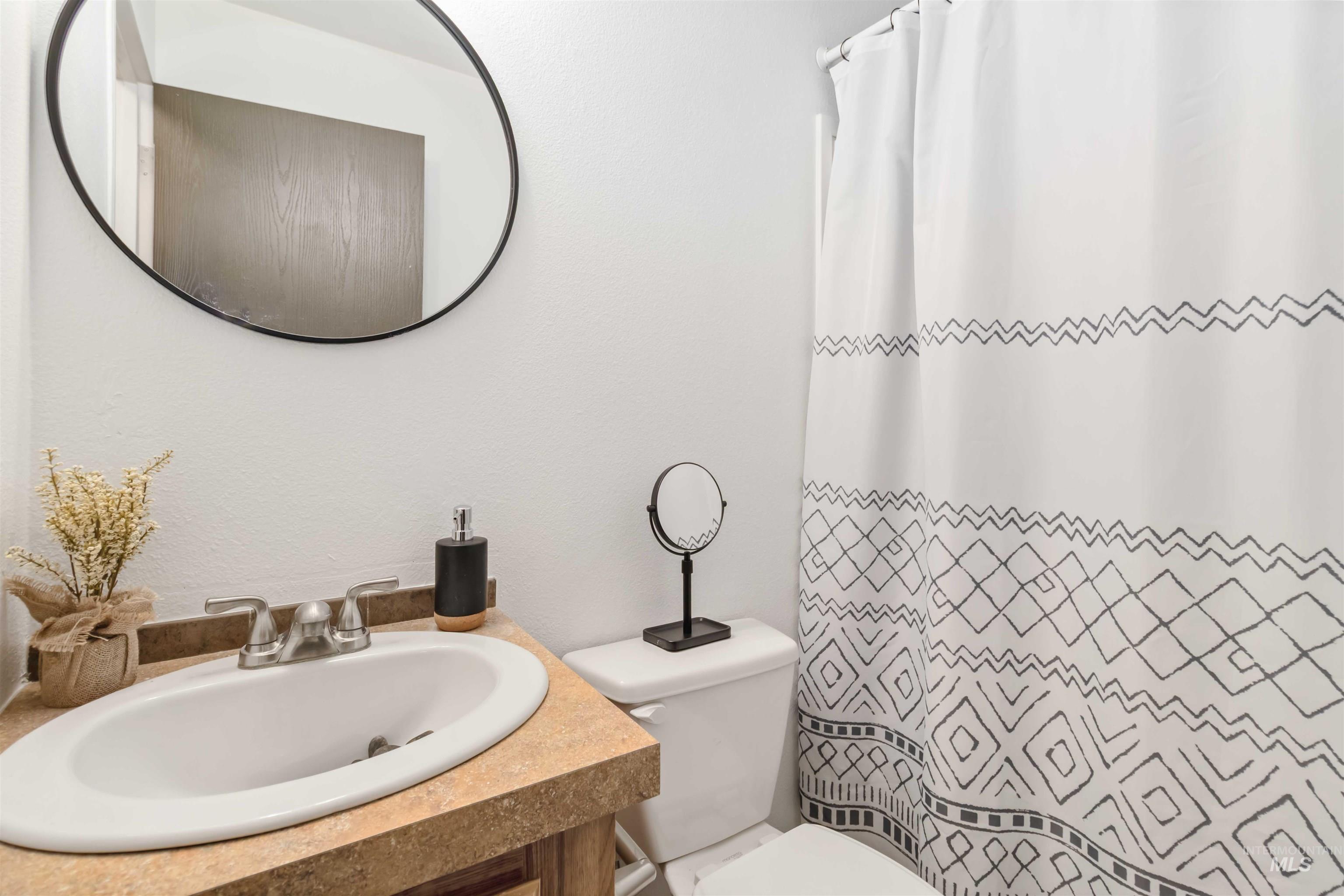 Bathroom with vanity and a shower with shower curtain