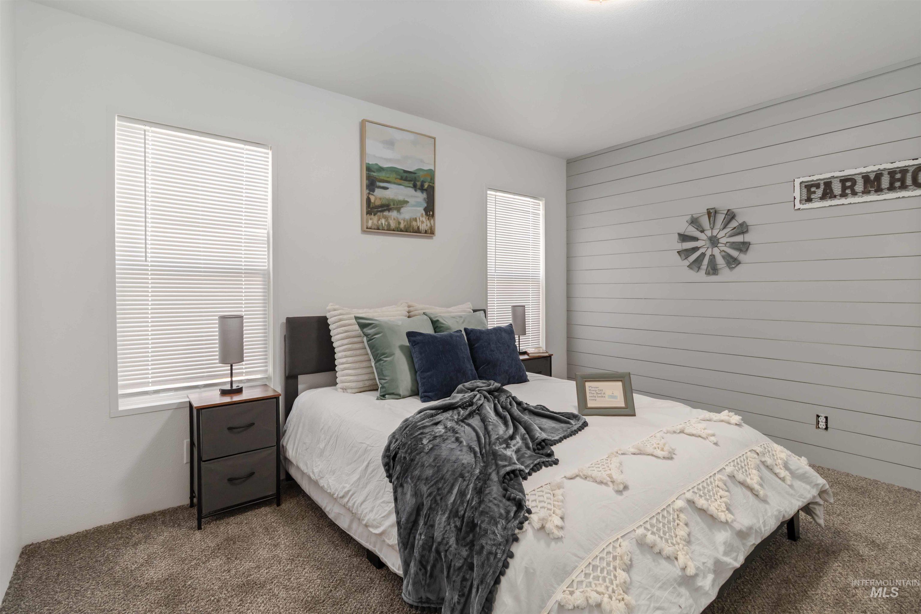 Carpeted bedroom with wooden walls