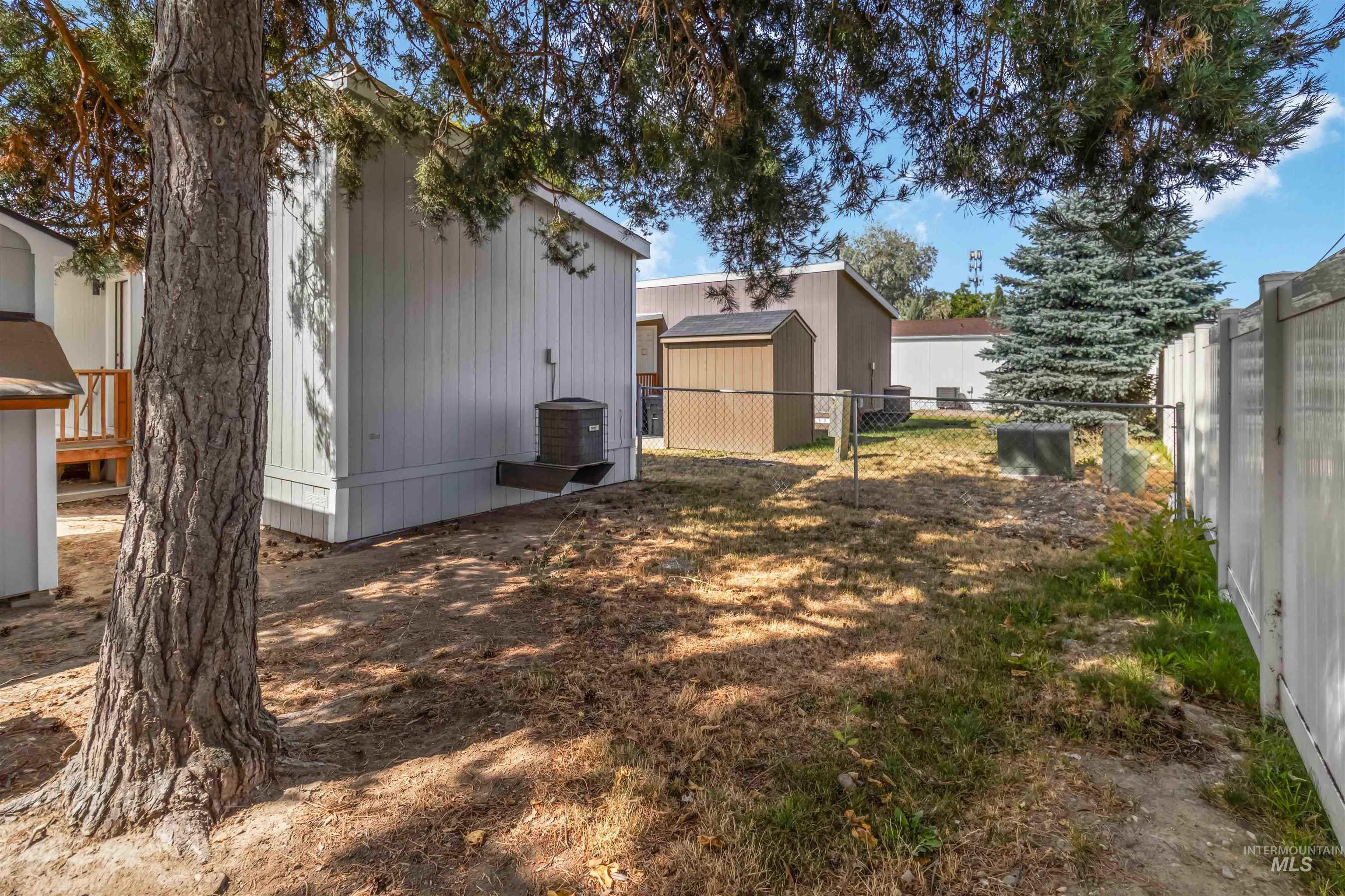 View of yard with a storage unit