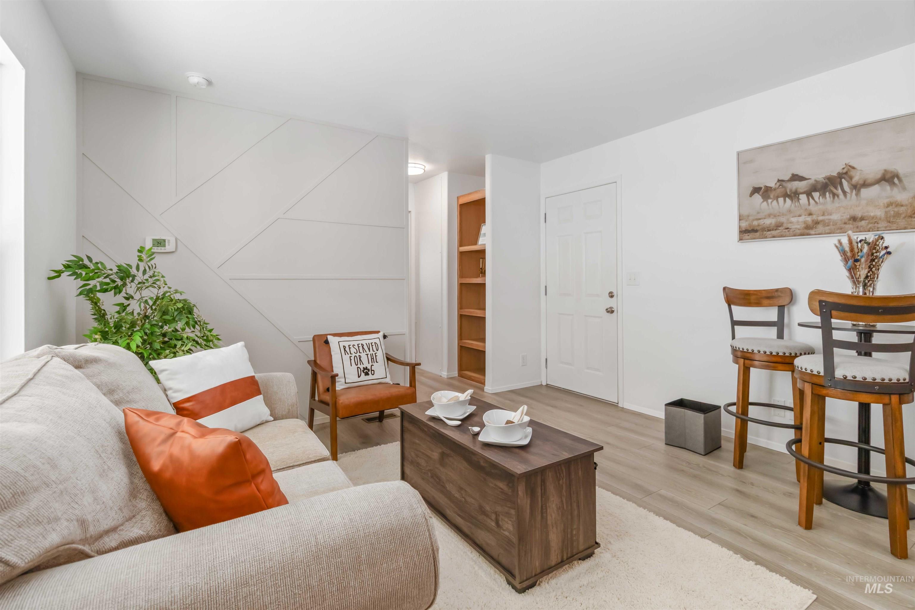 Living room with light wood-style floors and baseboards