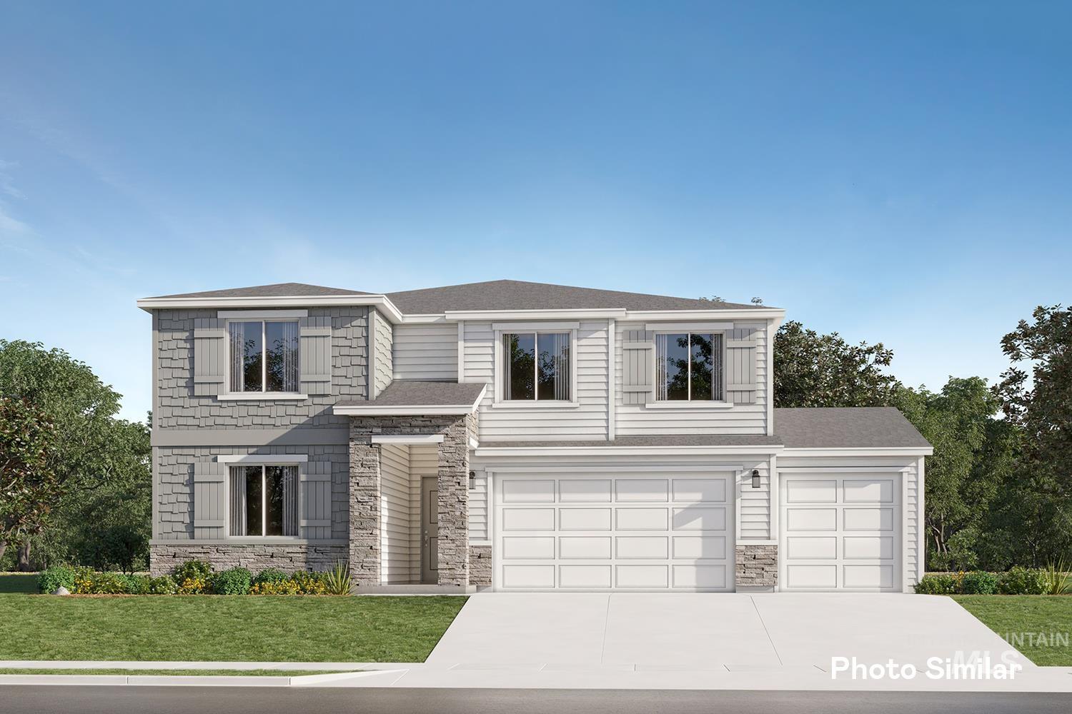 View of front of property featuring driveway, a front yard, stone siding, and a garage
