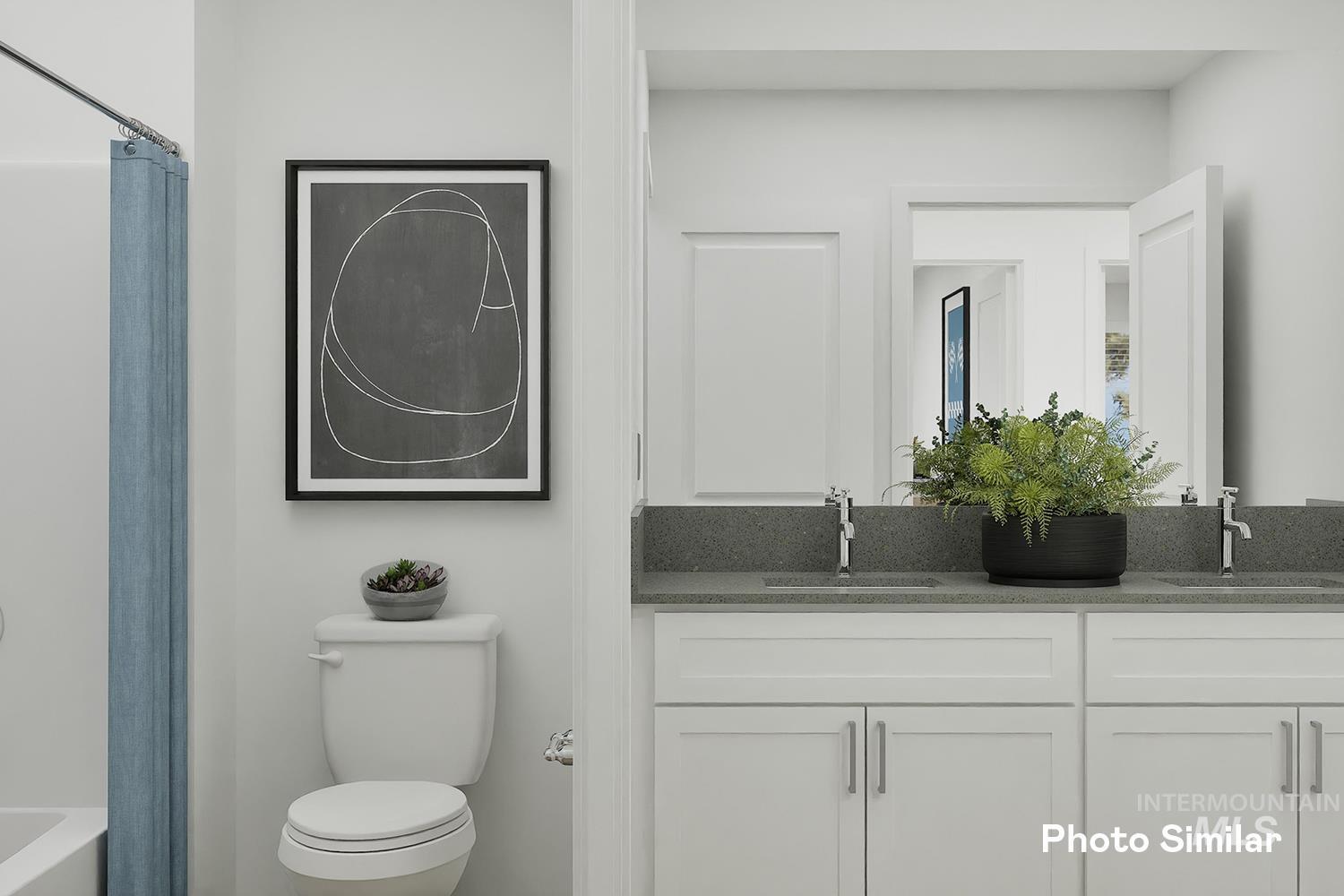 Bathroom featuring double vanity and shower / bathtub combination with curtain