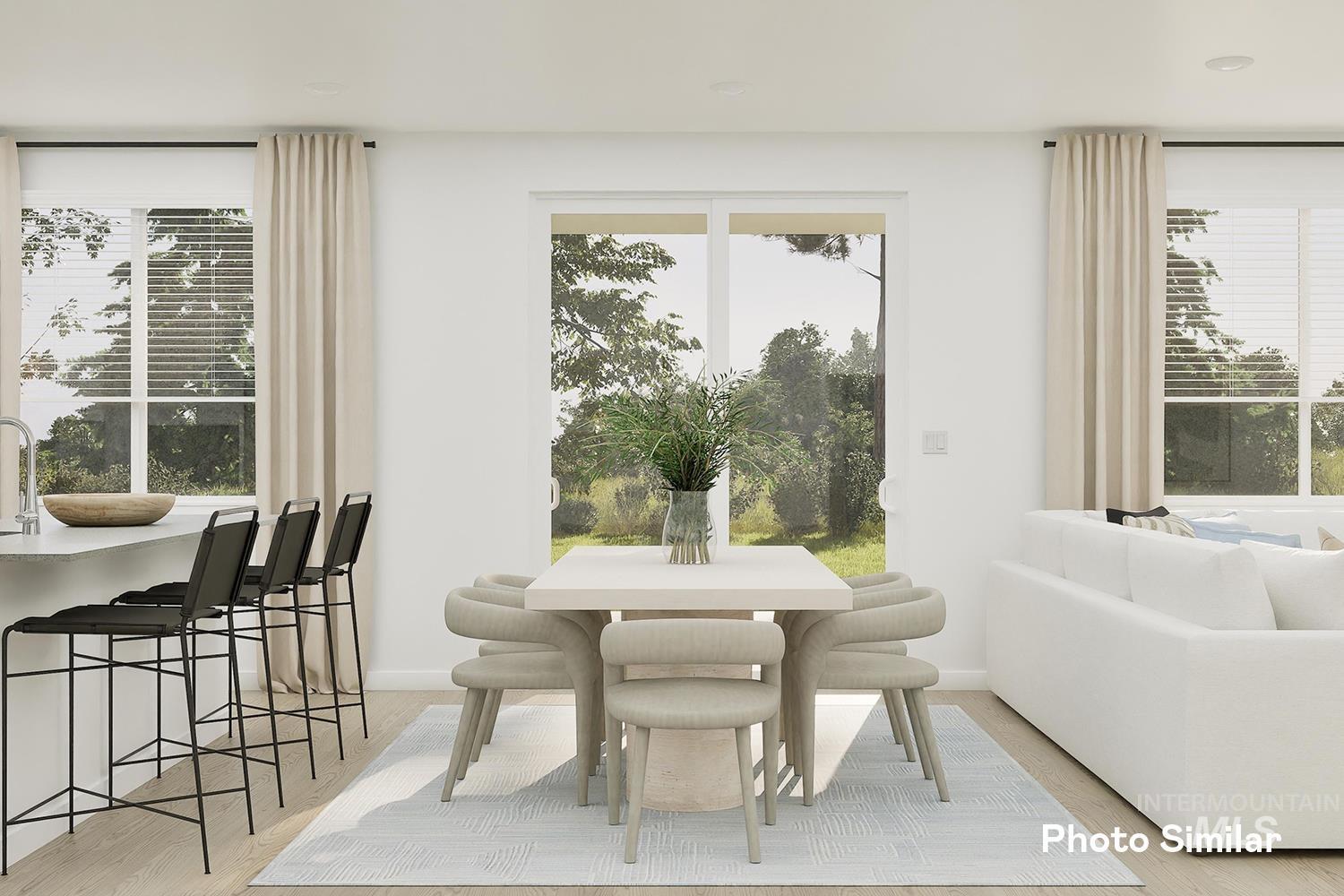 Dining space with plenty of natural light and light wood finished floors