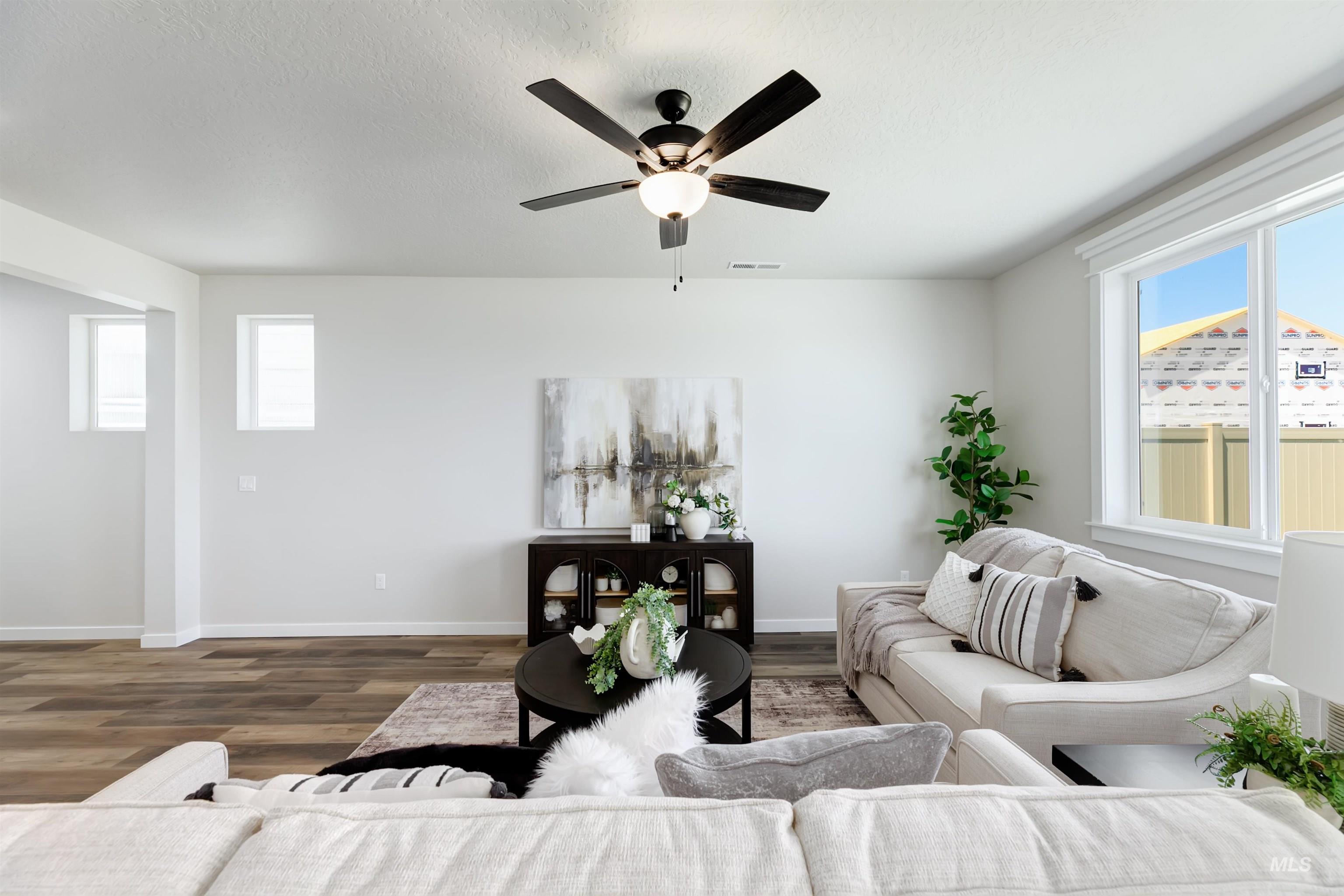 Living room featuring wood finished floors and ceiling fan