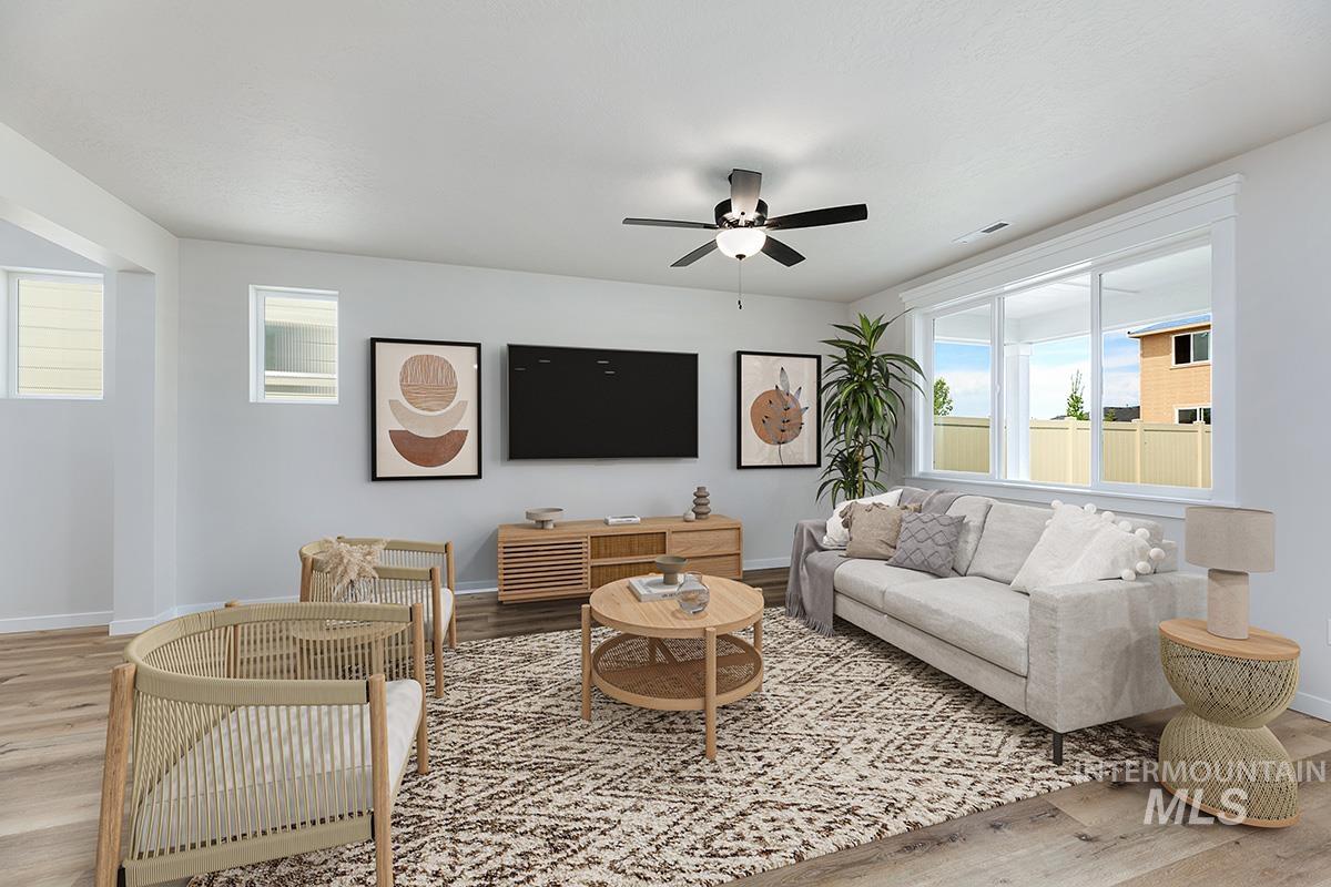 Living area with light wood-style floors and ceiling fan