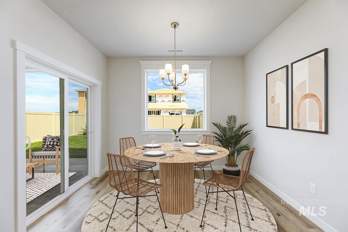 Dining space featuring light wood-style floors and a chandelier