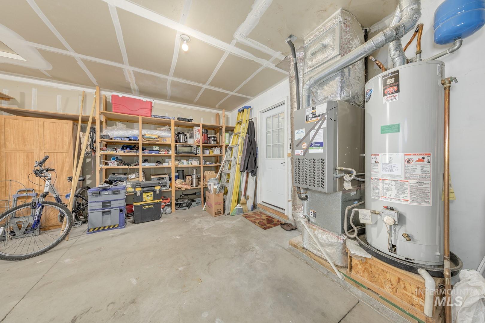 Utility room with gas water heater and heating unit