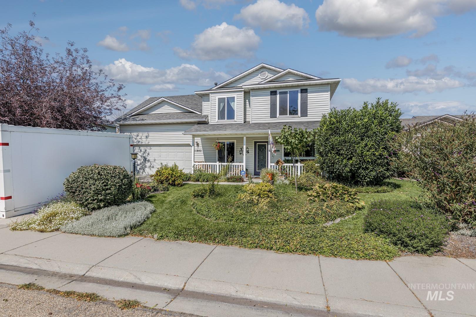 Traditional-style home featuring a porch and an attached garage