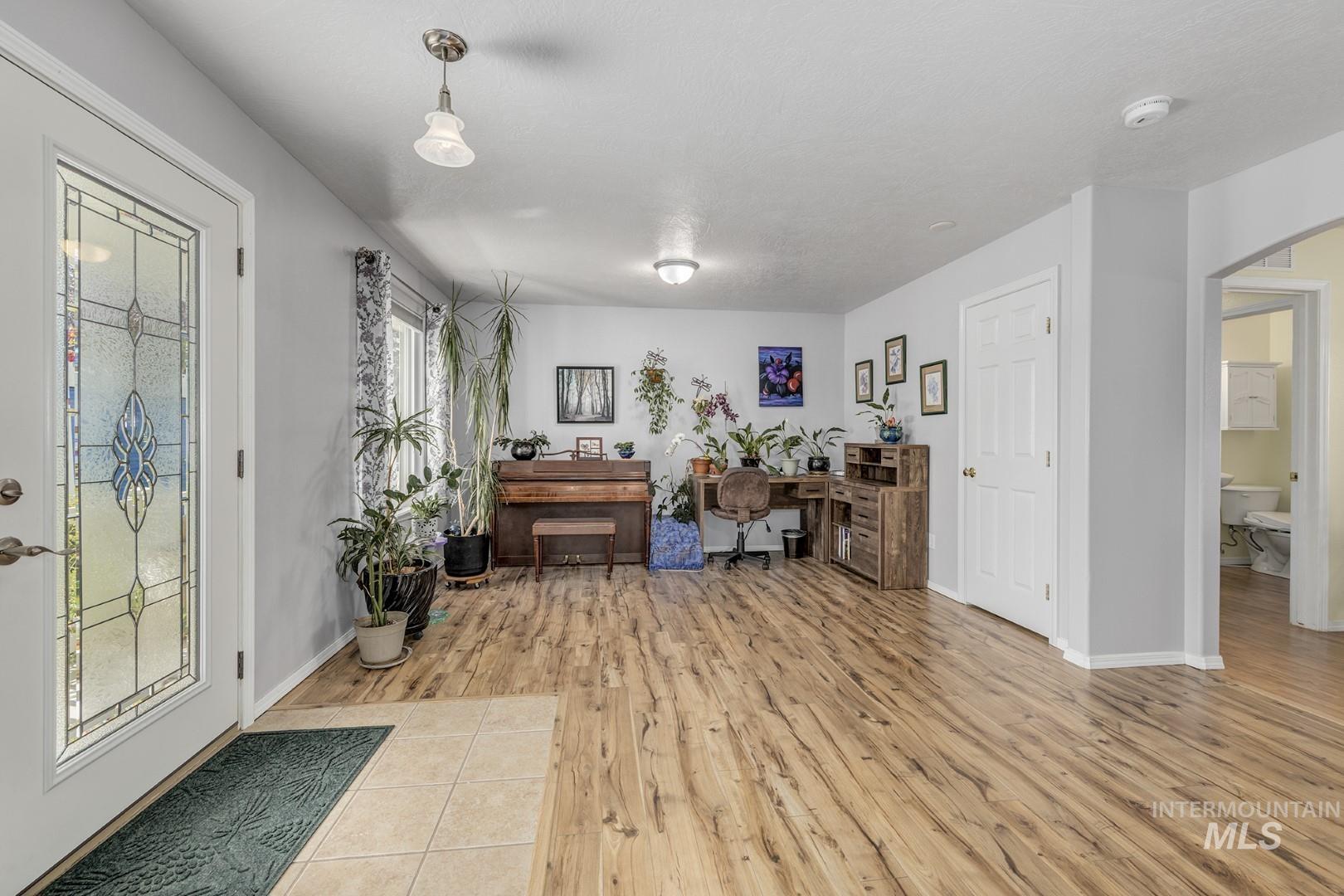 Foyer featuring light wood-type flooring and arched walkways