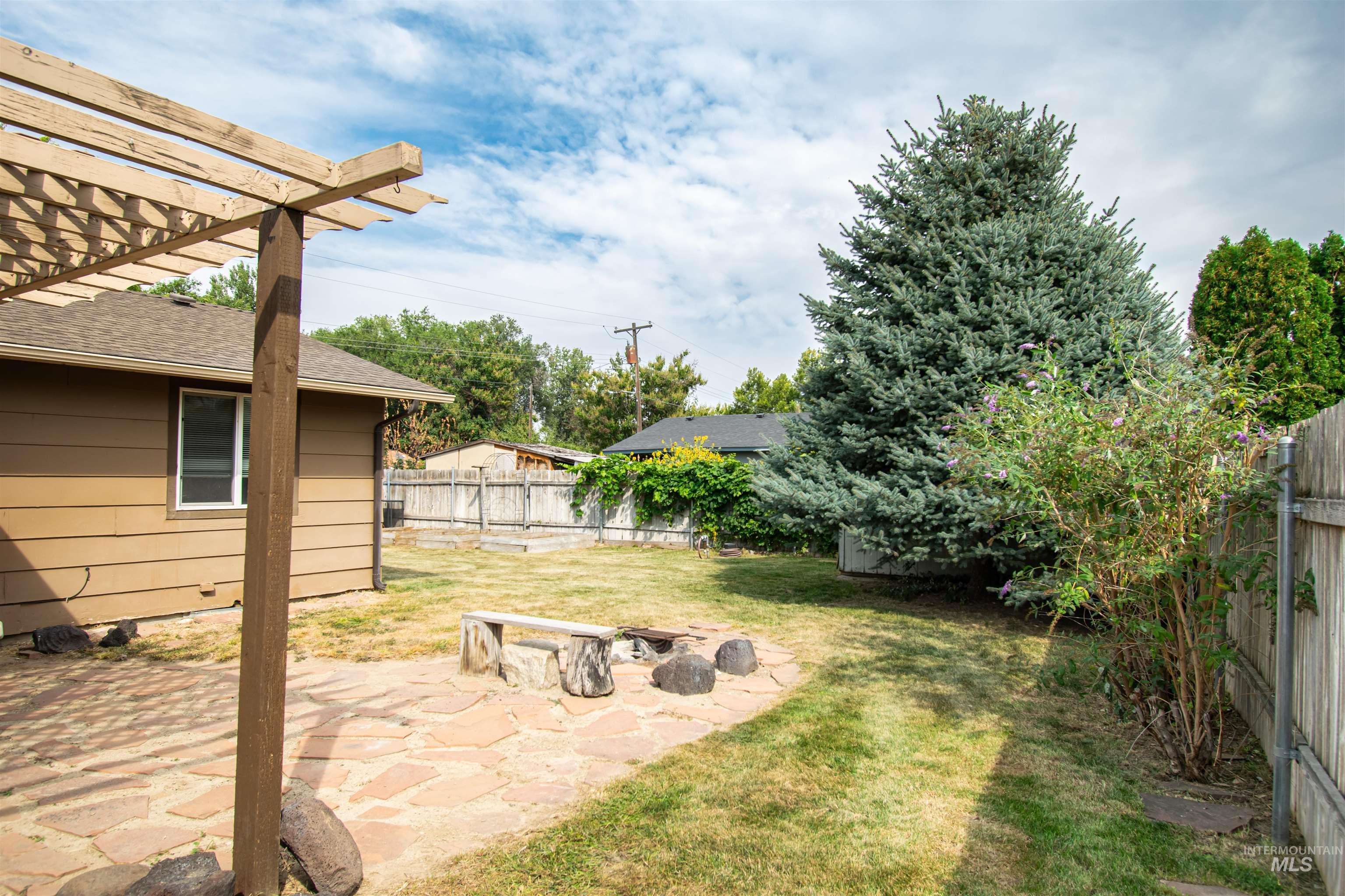 Fenced backyard with a patio and a pergola