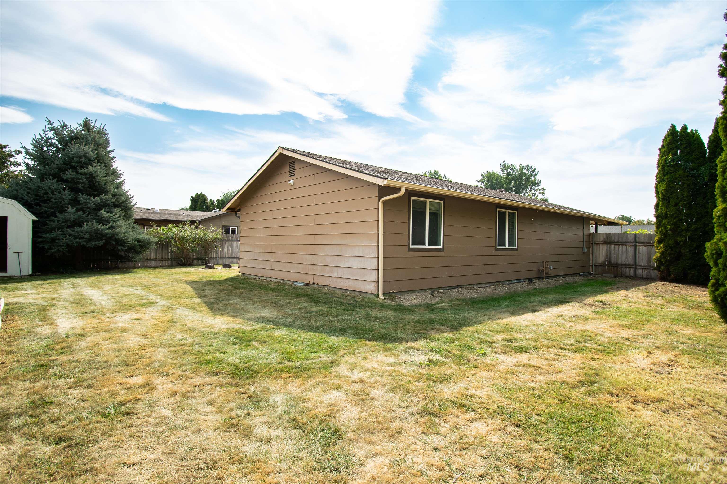 View of side of home with an outdoor structure