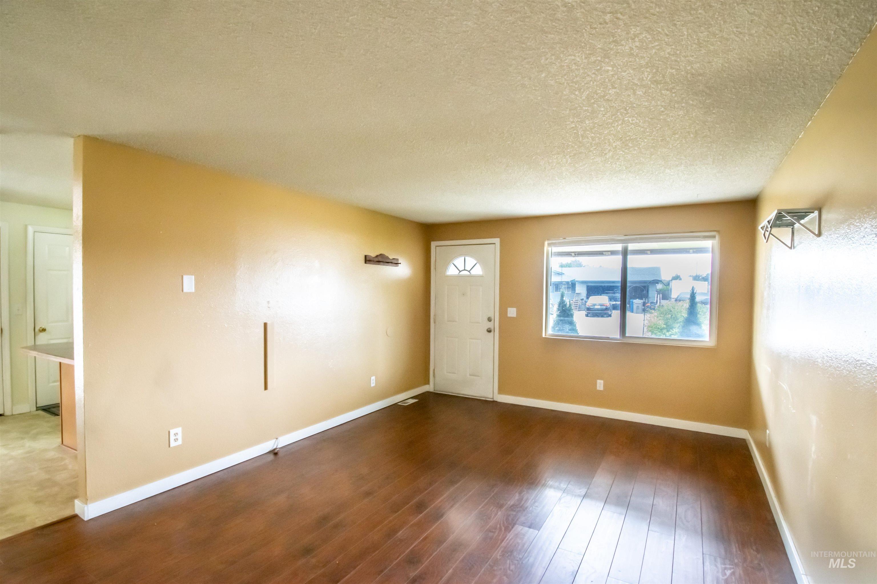 Foyer entrance featuring hardwood / wood-style flooring and a textured ceiling