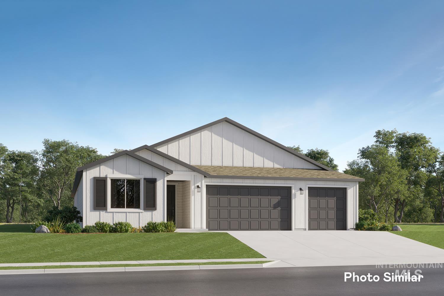 View of front of home featuring a front yard, a garage, driveway, board and batten siding, and roof with shingles