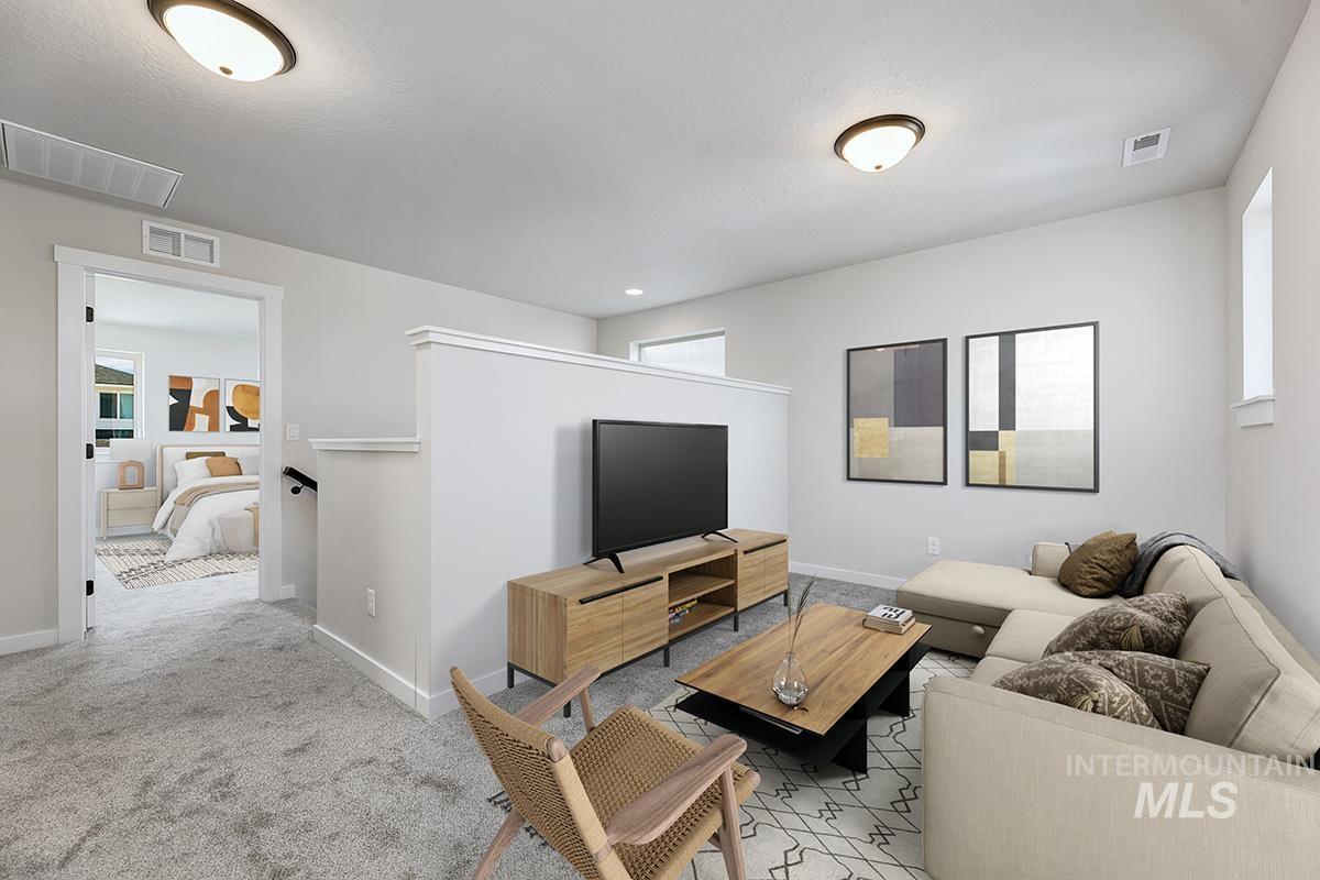 Carpeted living room with baseboards