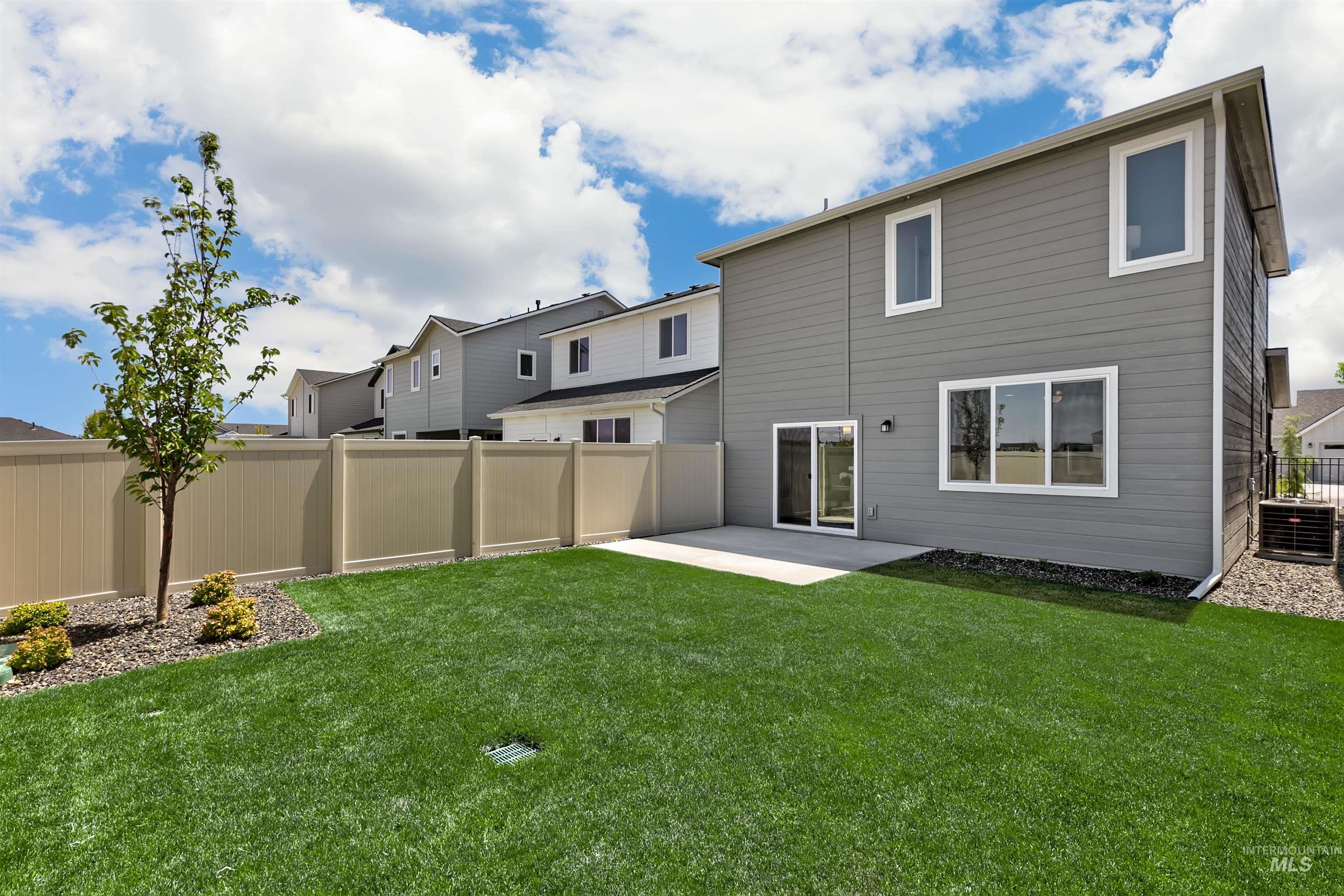 Rear view of property with a patio and a fenced backyard