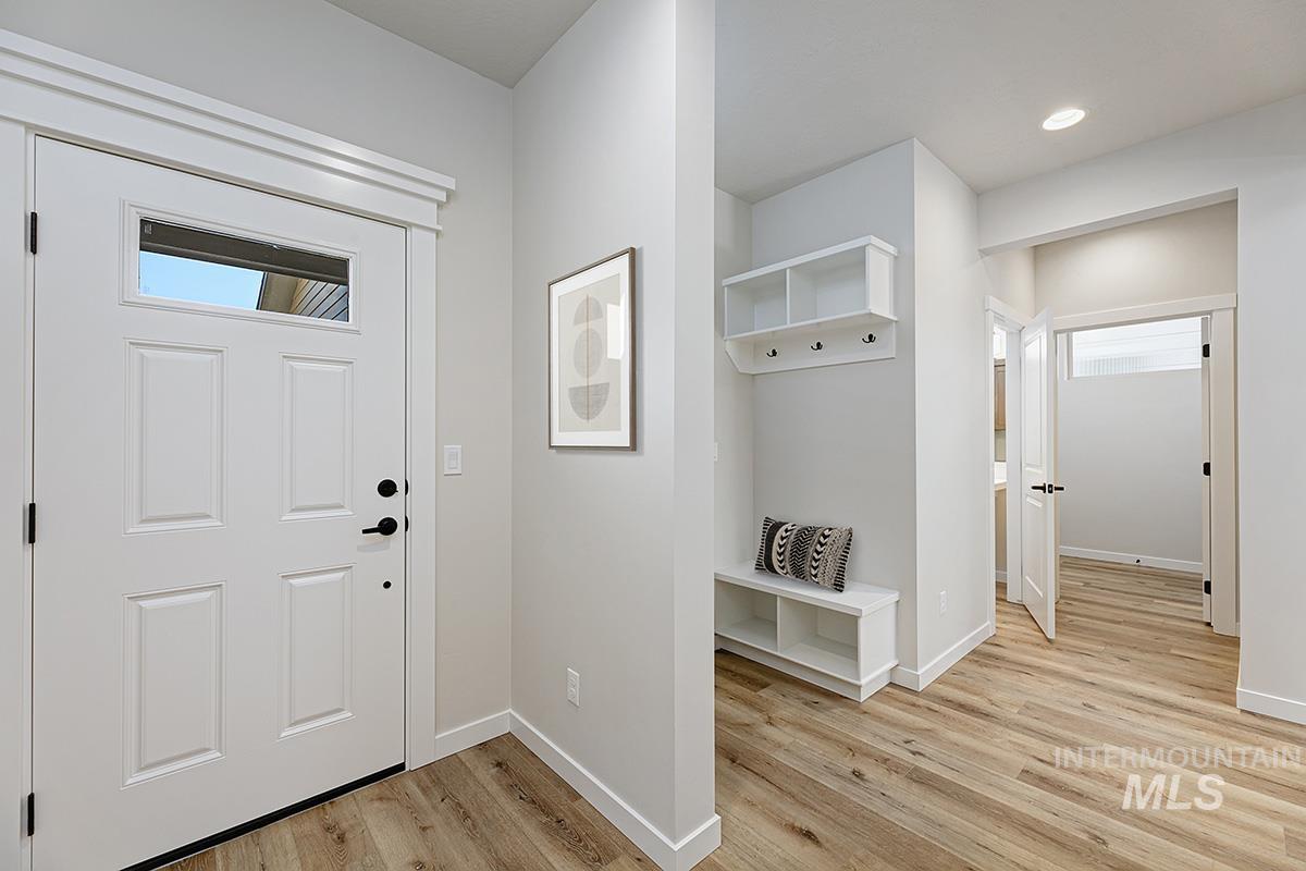 Entryway with light wood-style floors and recessed lighting