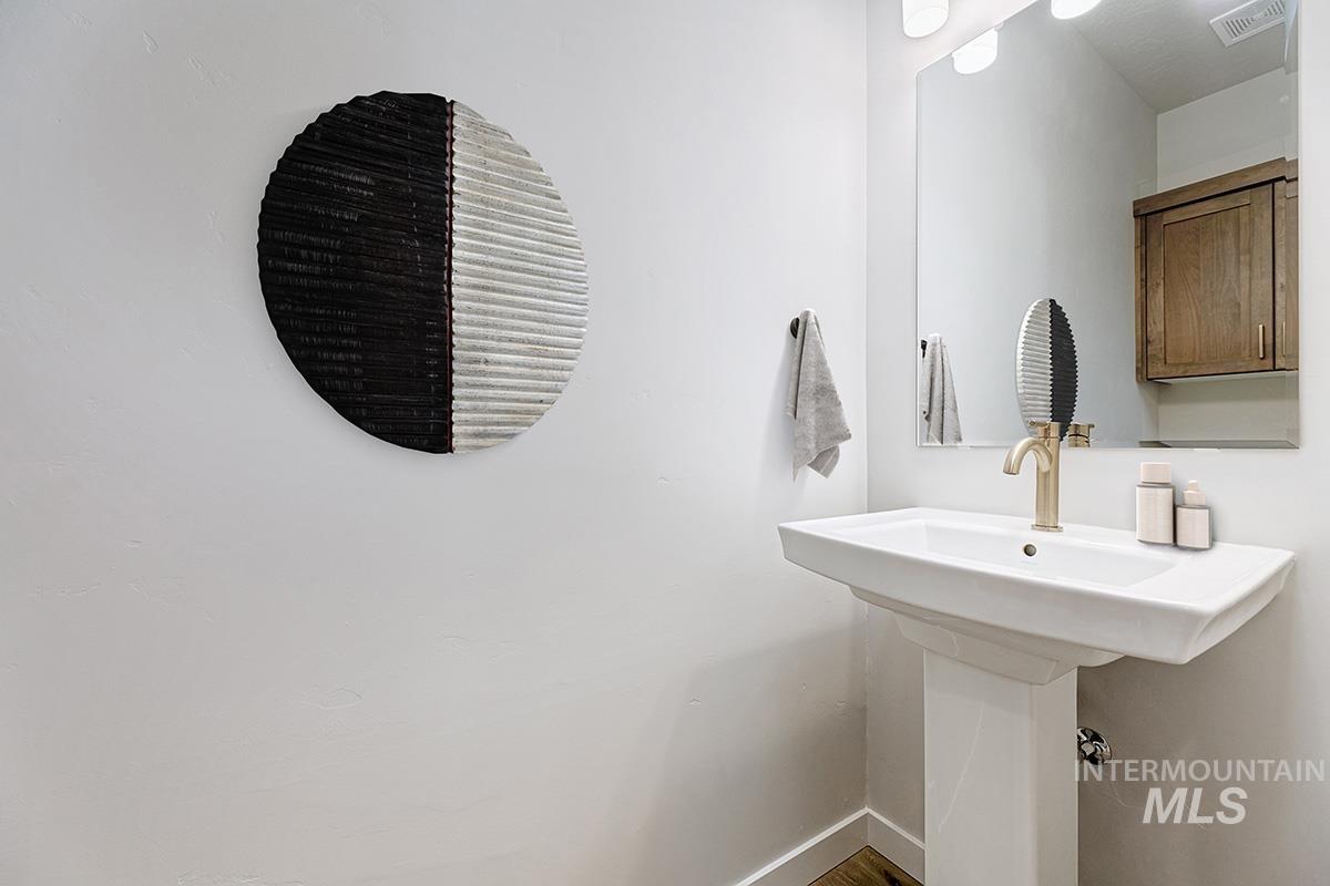 Bathroom featuring baseboards and a sink