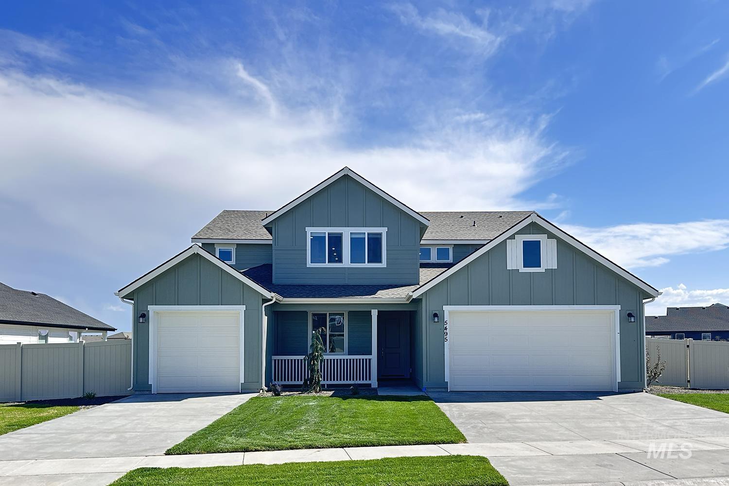 Craftsman-style house featuring board and batten siding, a shingled roof, driveway, a porch, and an attached garage