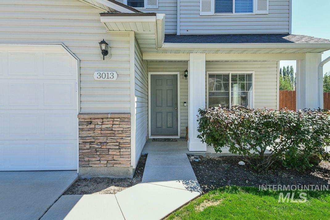 Doorway to property featuring stone siding and covered porch