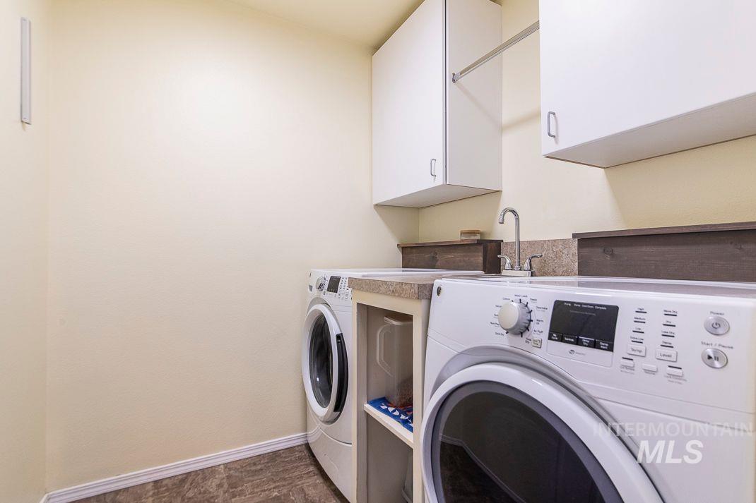 Laundry area featuring cabinet space and washing machine and dryer