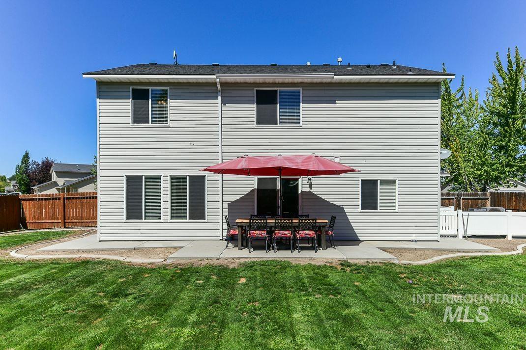 Rear view of property with a patio and a fenced backyard