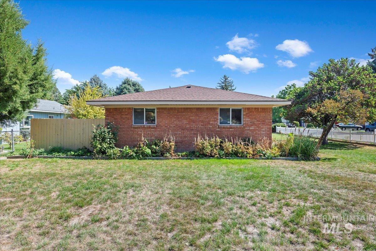 View of side of property featuring brick siding