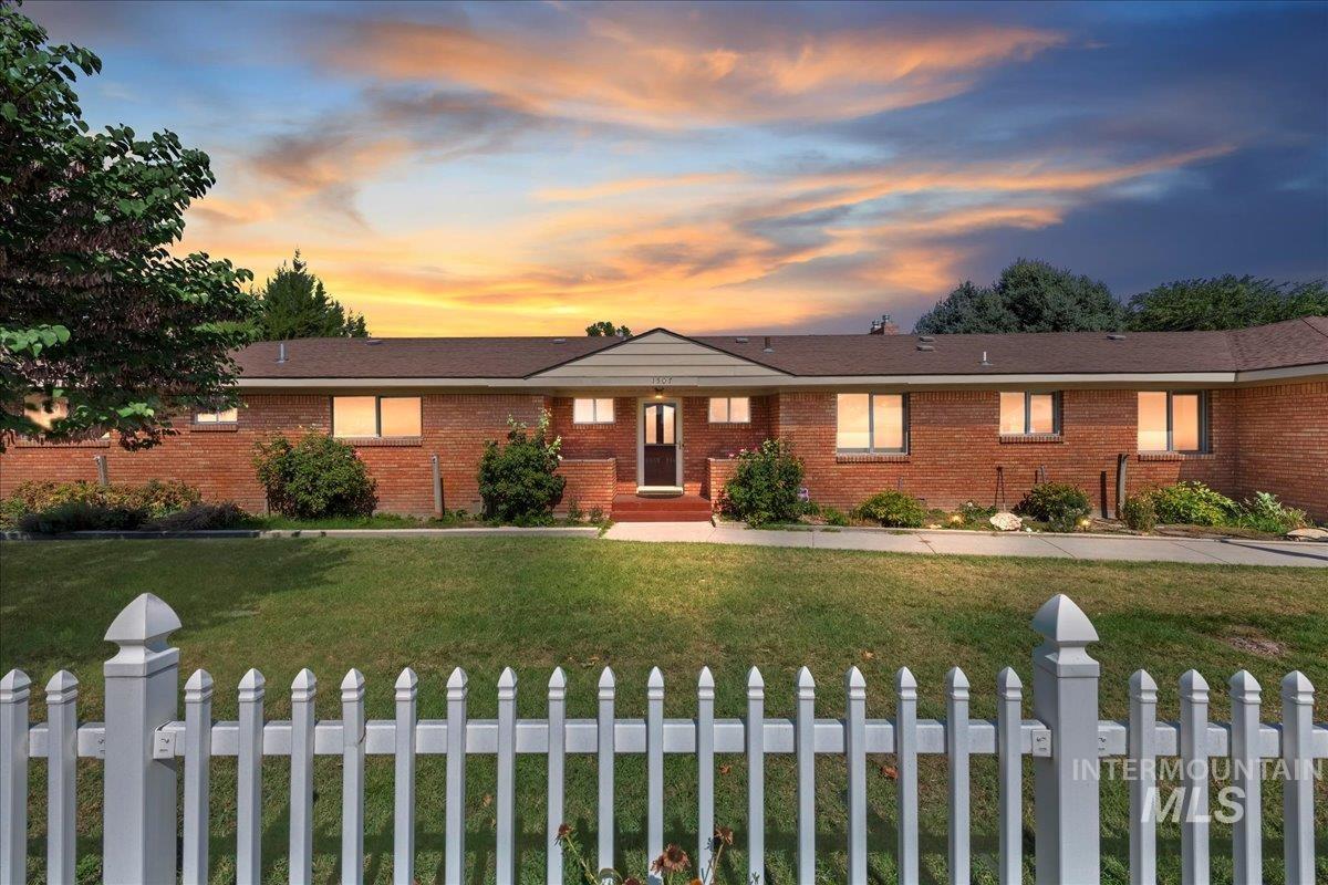 Ranch-style house with a yard and brick siding