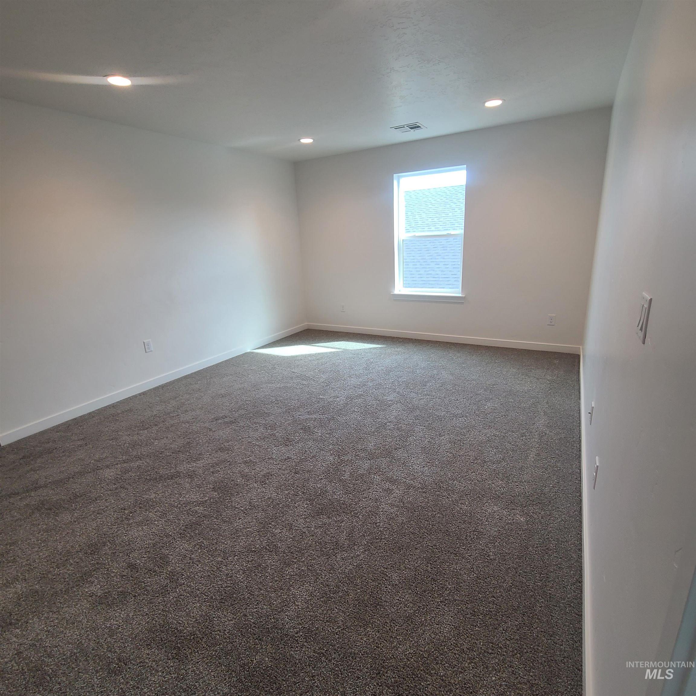 Unfurnished room featuring carpet flooring and recessed lighting
