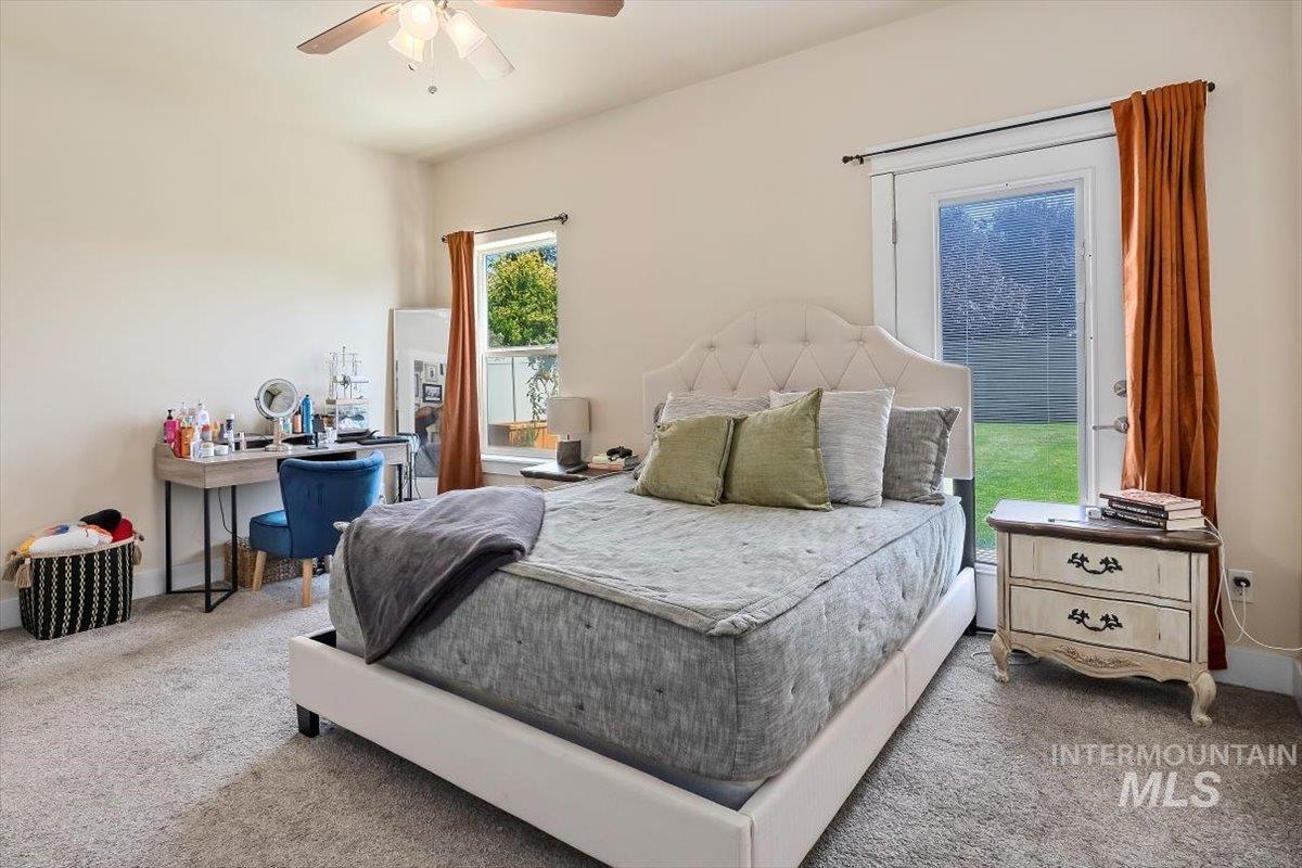 Bedroom with carpet floors and a ceiling fan