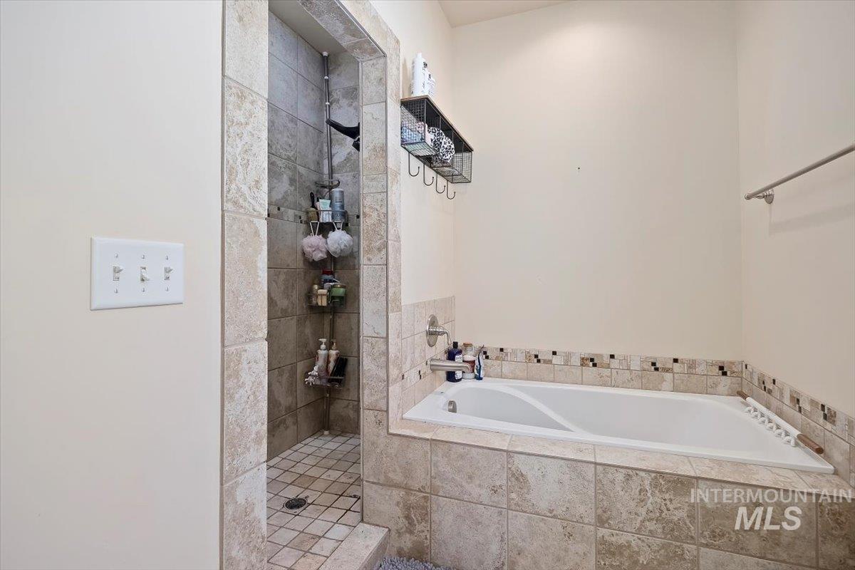 Bathroom with a walk in shower and a garden tub