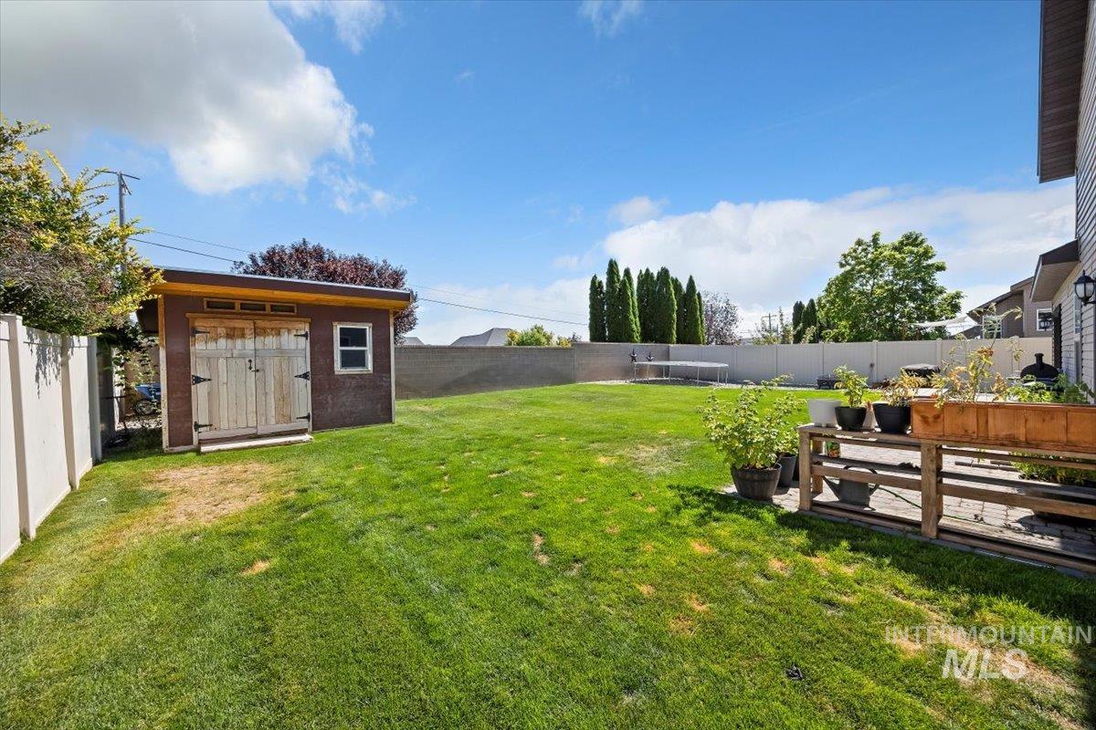 Fenced backyard with a storage shed