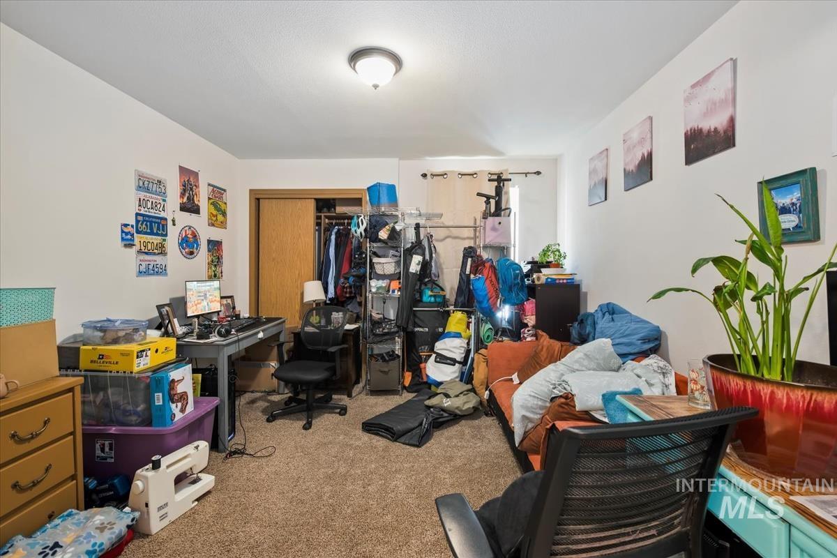 Carpeted bedroom featuring a closet
